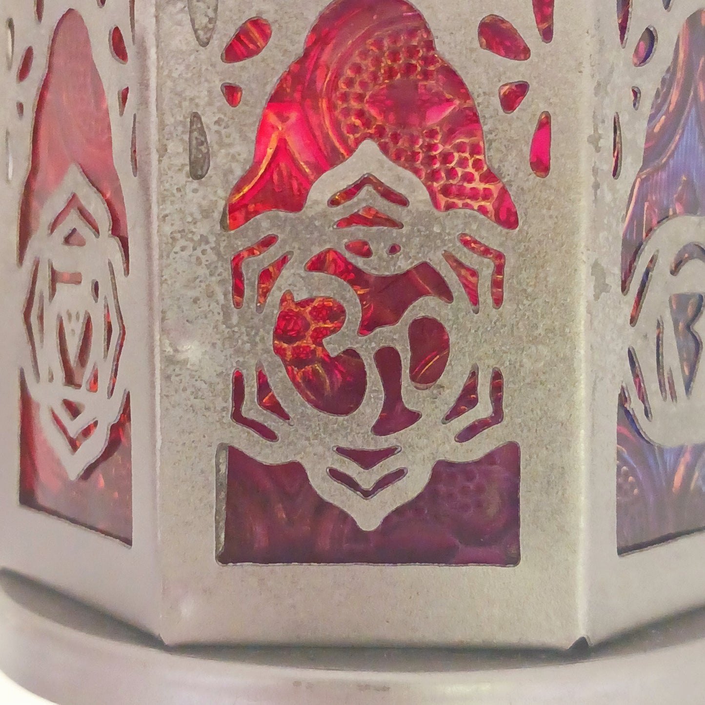 This delightful little seven-sided standing lantern has each side elegantly showcasing a chakra symbol. With a convenient bottom-opening door that doubles as a candle holder tray, this lantern is practical and attractive.