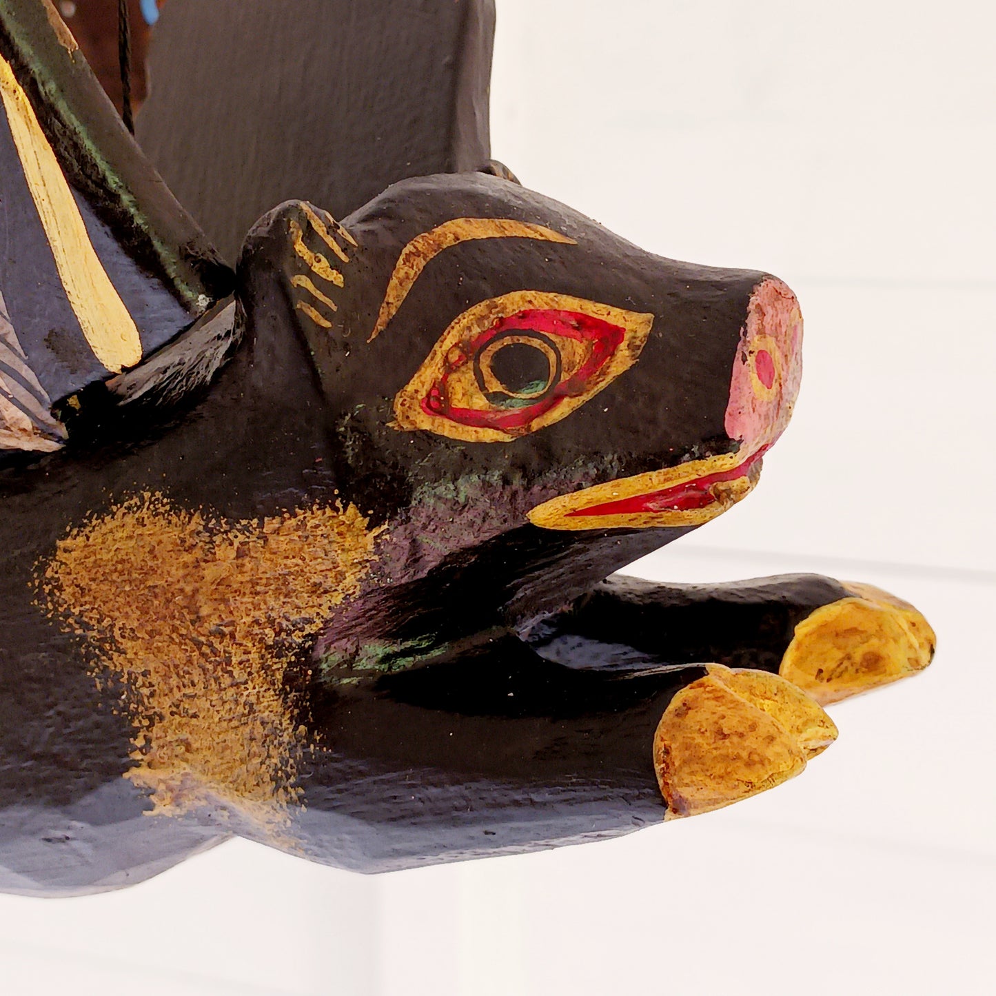 Invite protective energy and traditional charm into your home with this handcrafted Flying Pig Spirit Guardian from Bali. Known locally as a "Cradle Guardian," this winged figure is believed to ward off negative entities and is often placed in temples or homes, suspended from elevated areas like doorways or windows. Its downward-facing posture channels protection, while the strong twine loop allows for easy hanging.