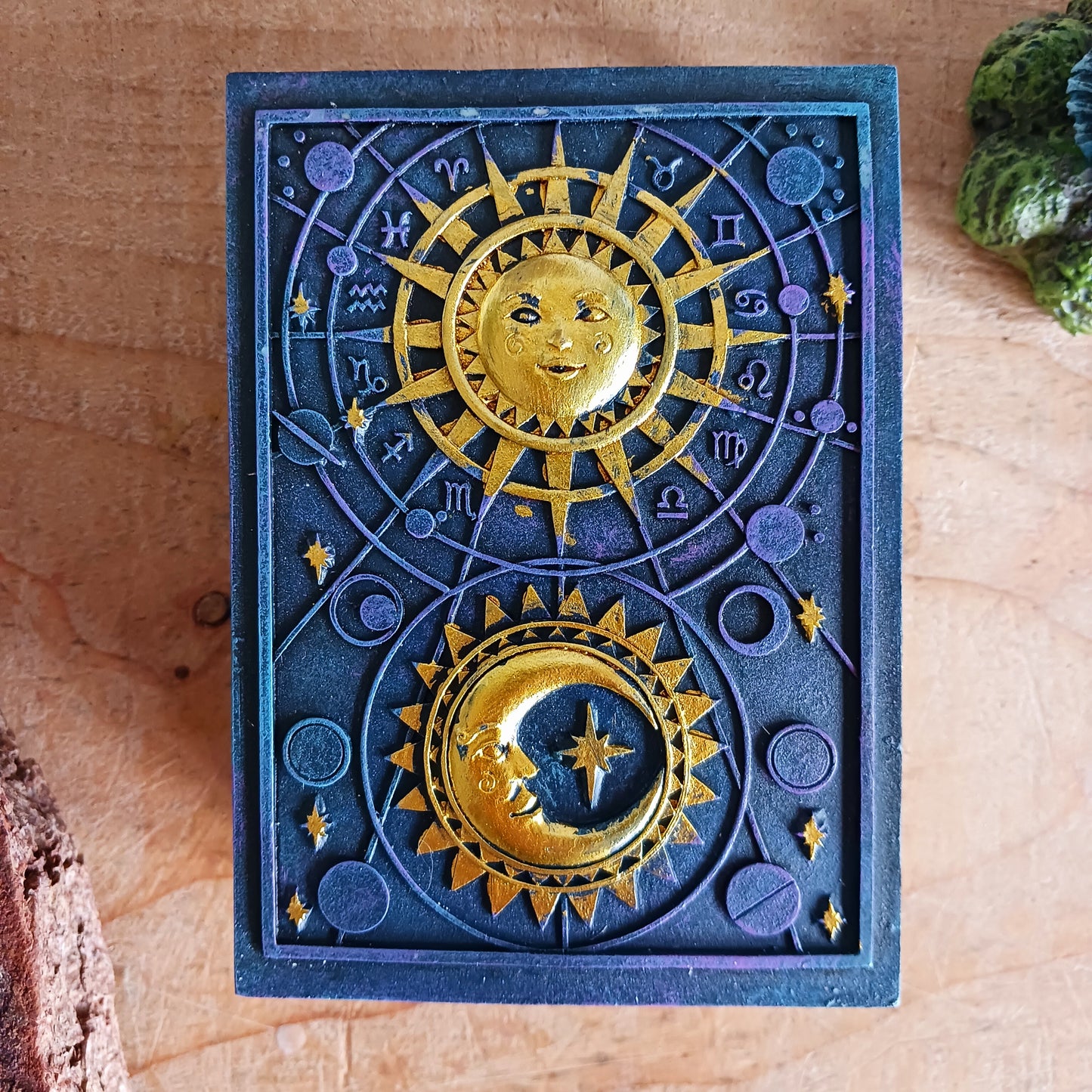 This unusual decorated resin box has raised astrology symbols and a detailed sun and moon design with a gold finish.
This celestial style is perfect for holding trinkets, crystals and other small objects for safe keeping.