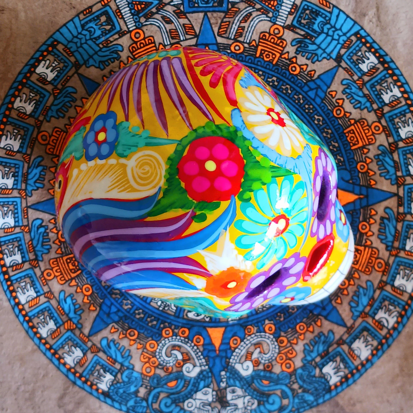 These fun ceramic sugar skull ornaments have been beautifully painted in bright colours and finished with a high shine glaze. They are a popular item during Día de Los Muertos or Day of the Dead festivities, held in Mexico every November to celebrate welcoming the souls of their deceased relatives back for a time of food, drink and celebration.