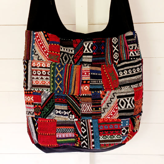 This shoulder bag is a great size which makes it ideal for taking shopping or carrying to class. It has a handy inside zipped pocket, perfect for your phone or purse. The design is made from a patchwork of the popular Thai weave material and comes fully lined with a secure zip fastening.