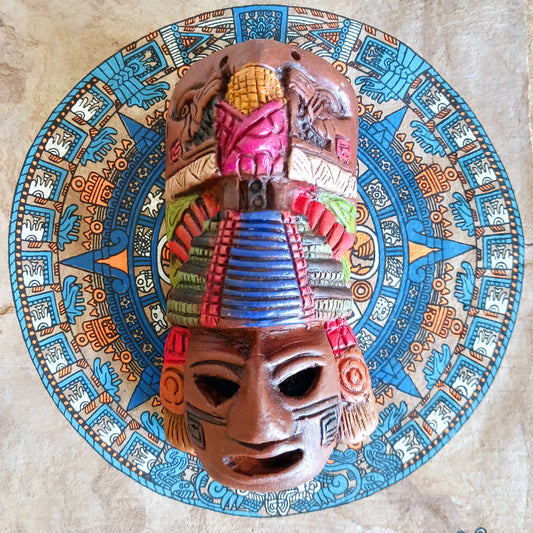 This little, handcrafted ceramic mask depicts a Mayan god, decorated with a pyramid headdress. The famous pyramids of Chichén Itzá in Mexico include El Castillo, a pyramid dedicated to Kukulcan, a Mayan serpent god. They are a major attraction at the archaeological site, recognized as one of the new Seven Wonders of the World. The pyramid was built by the Mayan civilization between the 9th and 12th centuries CE.
