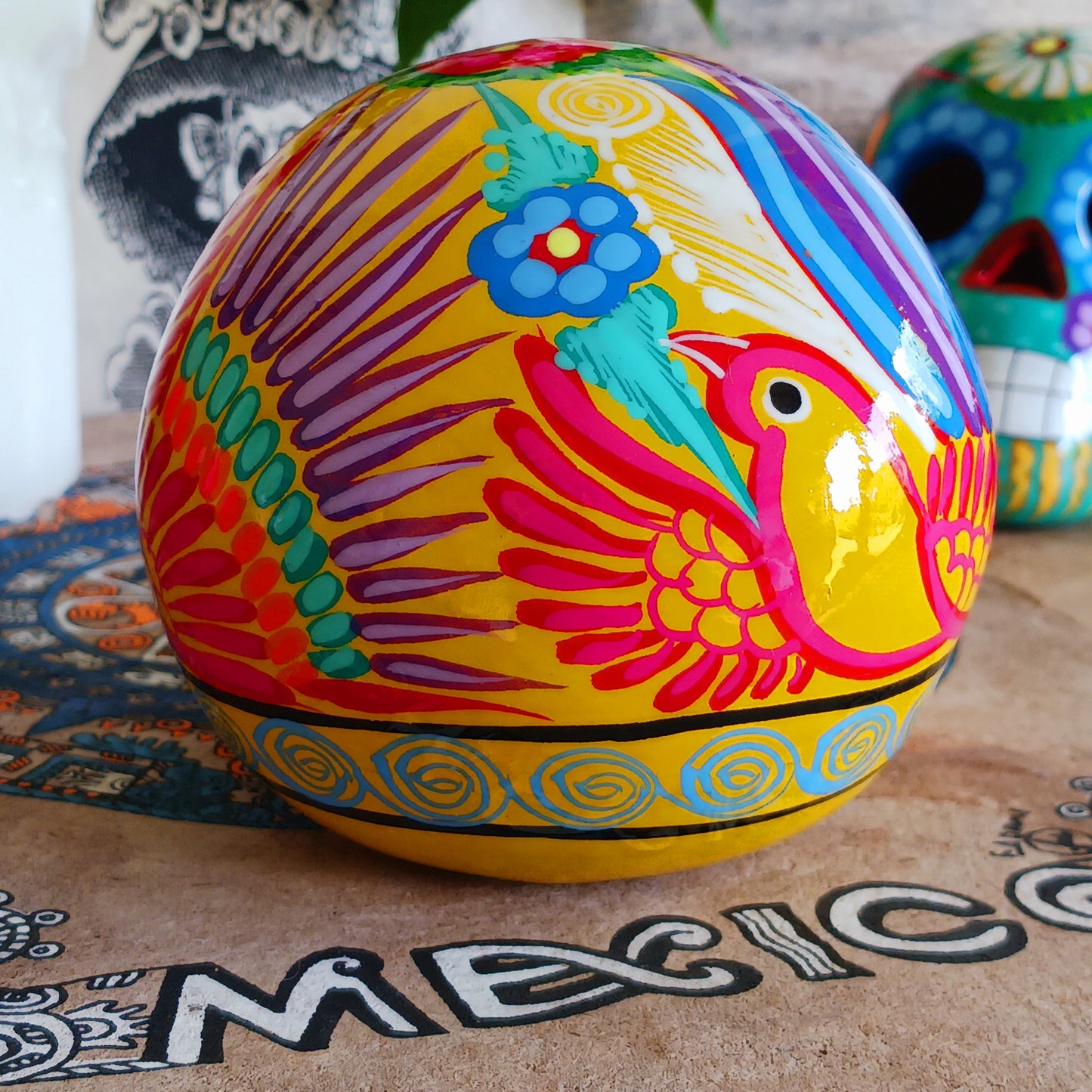 These fun ceramic sugar skull ornaments have been beautifully painted in bright colours and finished with a high shine glaze. They are a popular item during Día de Los Muertos or Day of the Dead festivities, held in Mexico every November to celebrate welcoming the souls of their deceased relatives back for a time of food, drink and celebration.