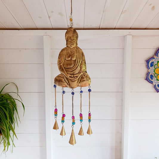 This lovely Buddha 5 bell windchime will bring serenity and cultural charm to any space.  Made in India from brass, this chime features a beautifully detailed Buddha adorned with colourful beads. 
 The five brass bells create a calming melody with every breeze, making it a perfect addition to meditation spaces, gardens, or tranquil home settings.