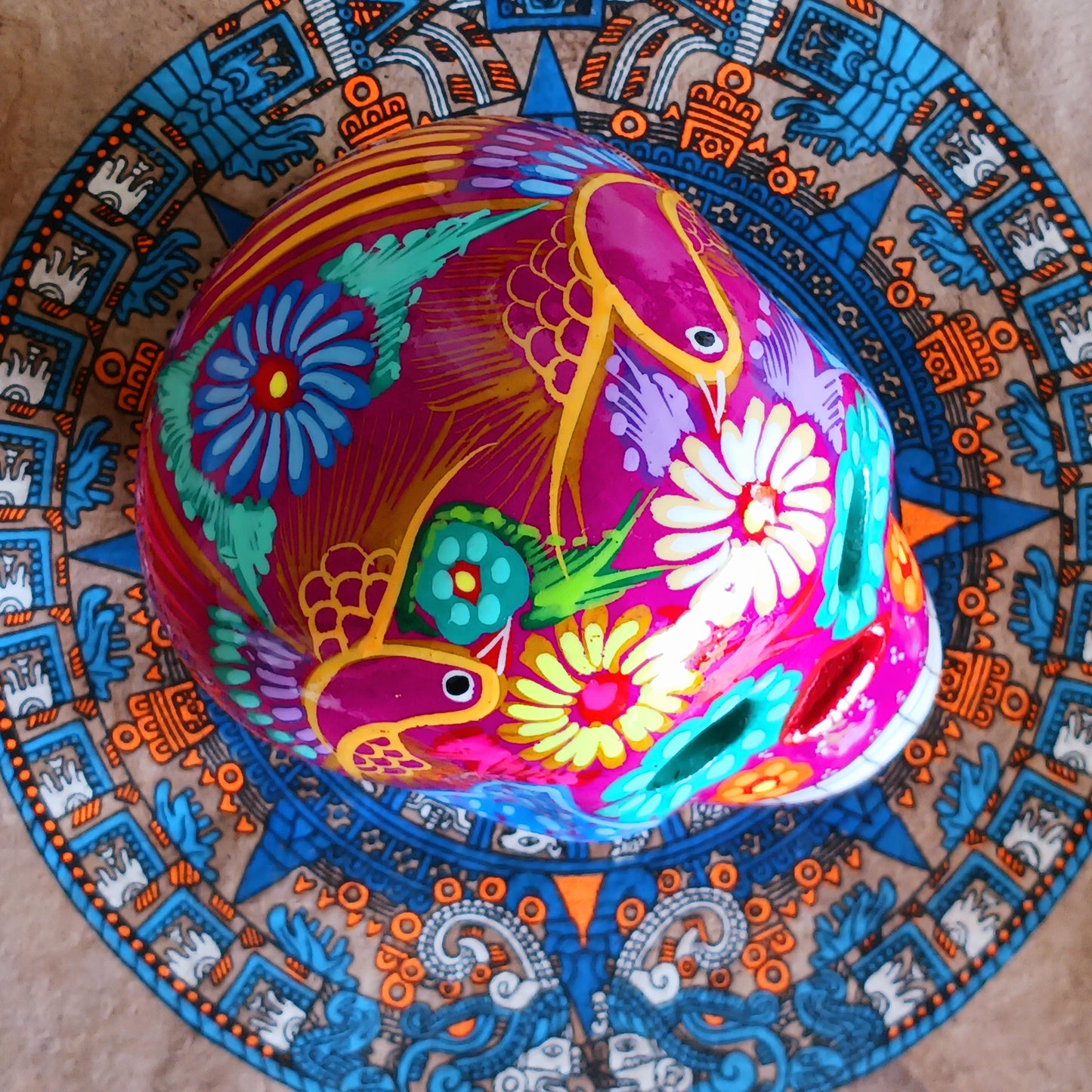 These fun ceramic sugar skull ornaments have been beautifully painted in bright colours and finished with a high shine glaze. They are a popular item during Día de Los Muertos or Day of the Dead festivities, held in Mexico every November to celebrate welcoming the souls of their deceased relatives back for a time of food, drink and celebration.