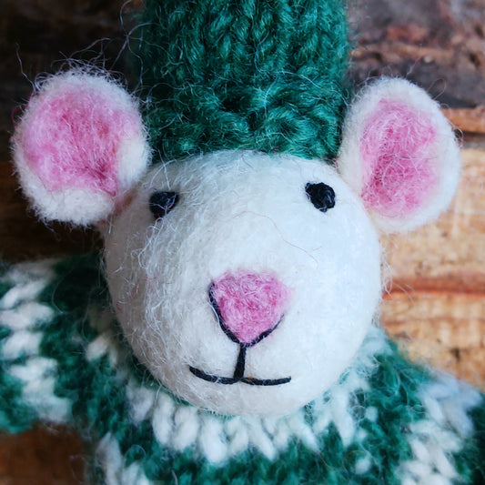 Meet our endearing little Christmas mice, dressed in vibrant elf knitwear, joyfully clutching a felt candy cane ready to spread festive cheer. Each ornament is lovingly handcrafted, capturing the magic and childlike wonder of the holiday season.