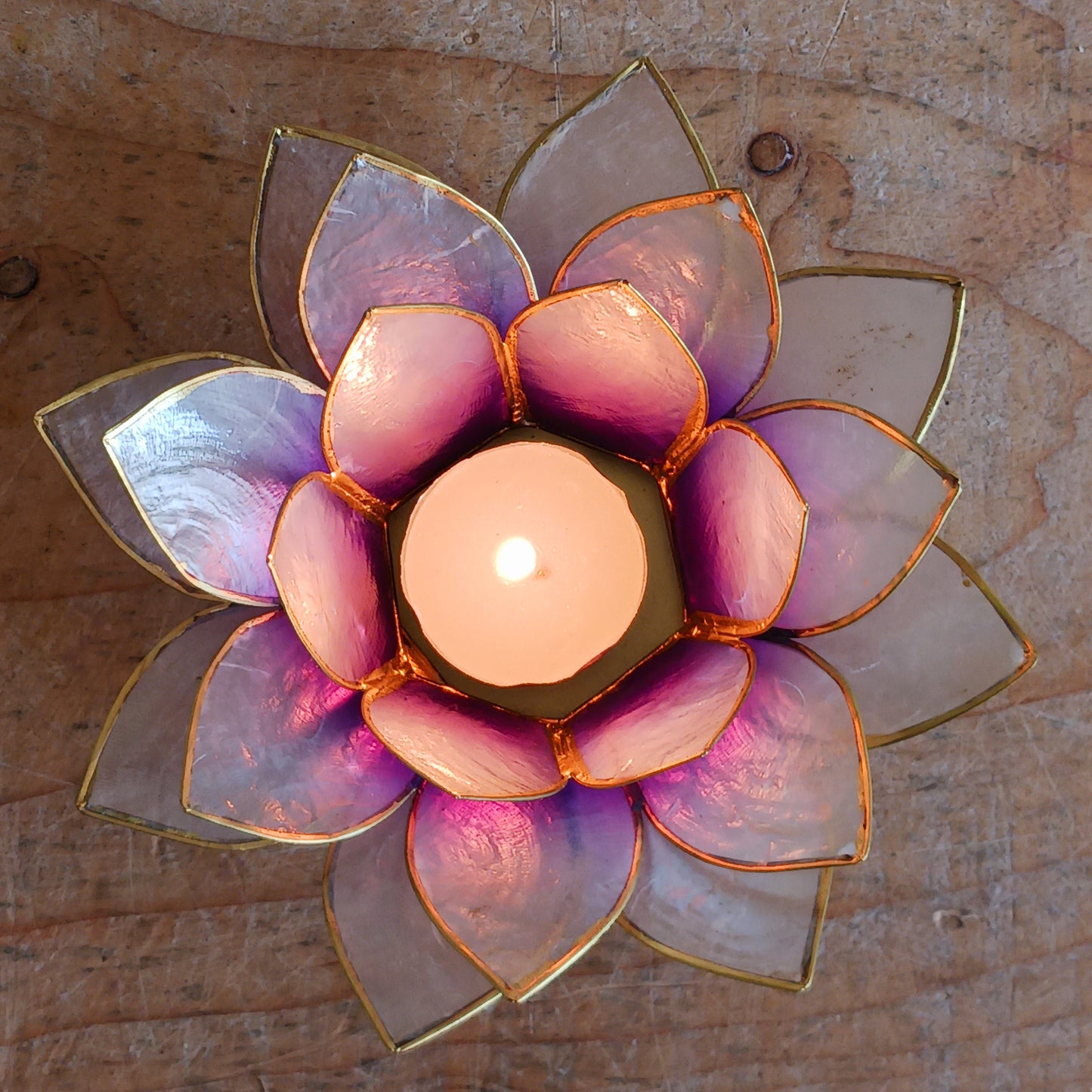The Lotus Flower is a symbol of achieving enlightenment, peacefulness and spirituality. This beautiful candle holder can be fitted with tealight candles or slightly larger candles. The diameter of the middle is roughly 5.5cm, so it will fit any candle with the same diameter.