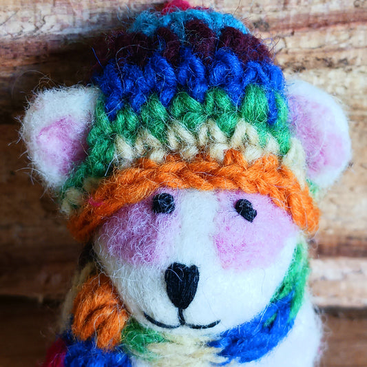 Bring instant festive cheer to your home with this adorable Christmas Tree Rabbit Decoration. Dressed in a hand-knitted rainbow hat and matching scarf, this charming little bunny captures the magic of the season at first sight. Its sweet black nose, expressive eyes, and cartoon-like ears bring out the childlike joy in anyone who sees it.