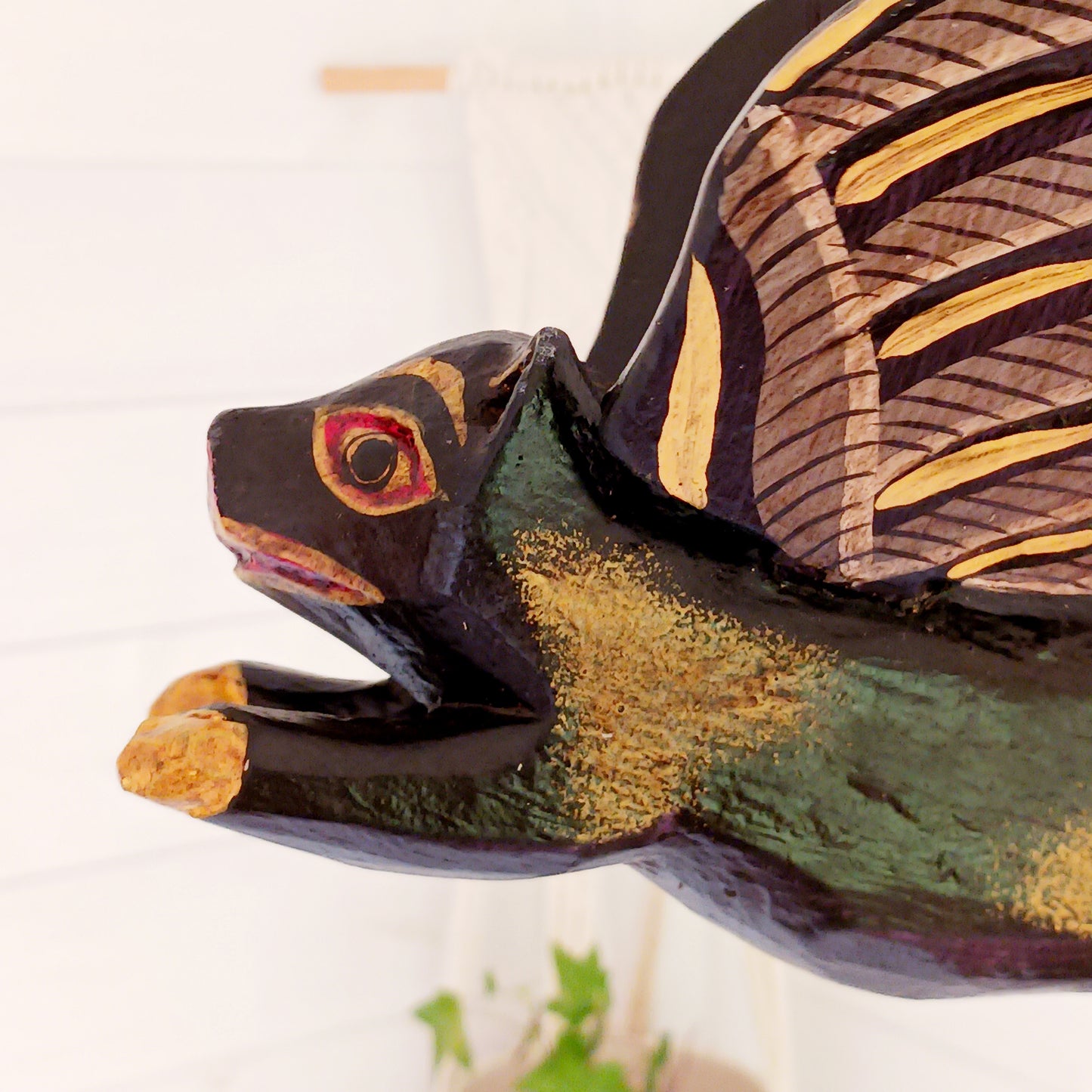 Invite protective energy and traditional charm into your home with this handcrafted Flying Pig Spirit Guardian from Bali. Known locally as a "Cradle Guardian," this winged figure is believed to ward off negative entities and is often placed in temples or homes, suspended from elevated areas like doorways or windows. Its downward-facing posture channels protection, while the strong twine loop allows for easy hanging.