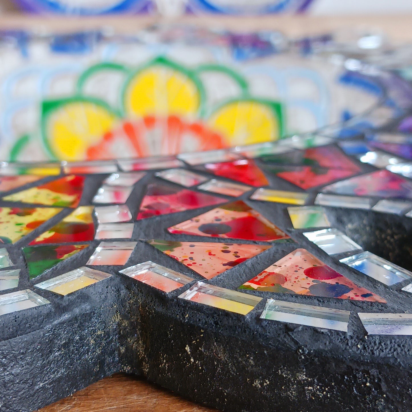 This beautiful sun shaped mirror is decoration with multicoloured glass mosaic tiles and finished on albesia wood frame.