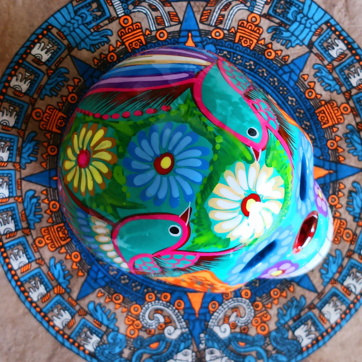 These fun ceramic sugar skull ornaments have been beautifully painted in bright colours and finished with a high shine glaze. They are a popular item during Día de Los Muertos or Day of the Dead festivities, held in Mexico every November to celebrate welcoming the souls of their deceased relatives back for a time of food, drink and celebration.