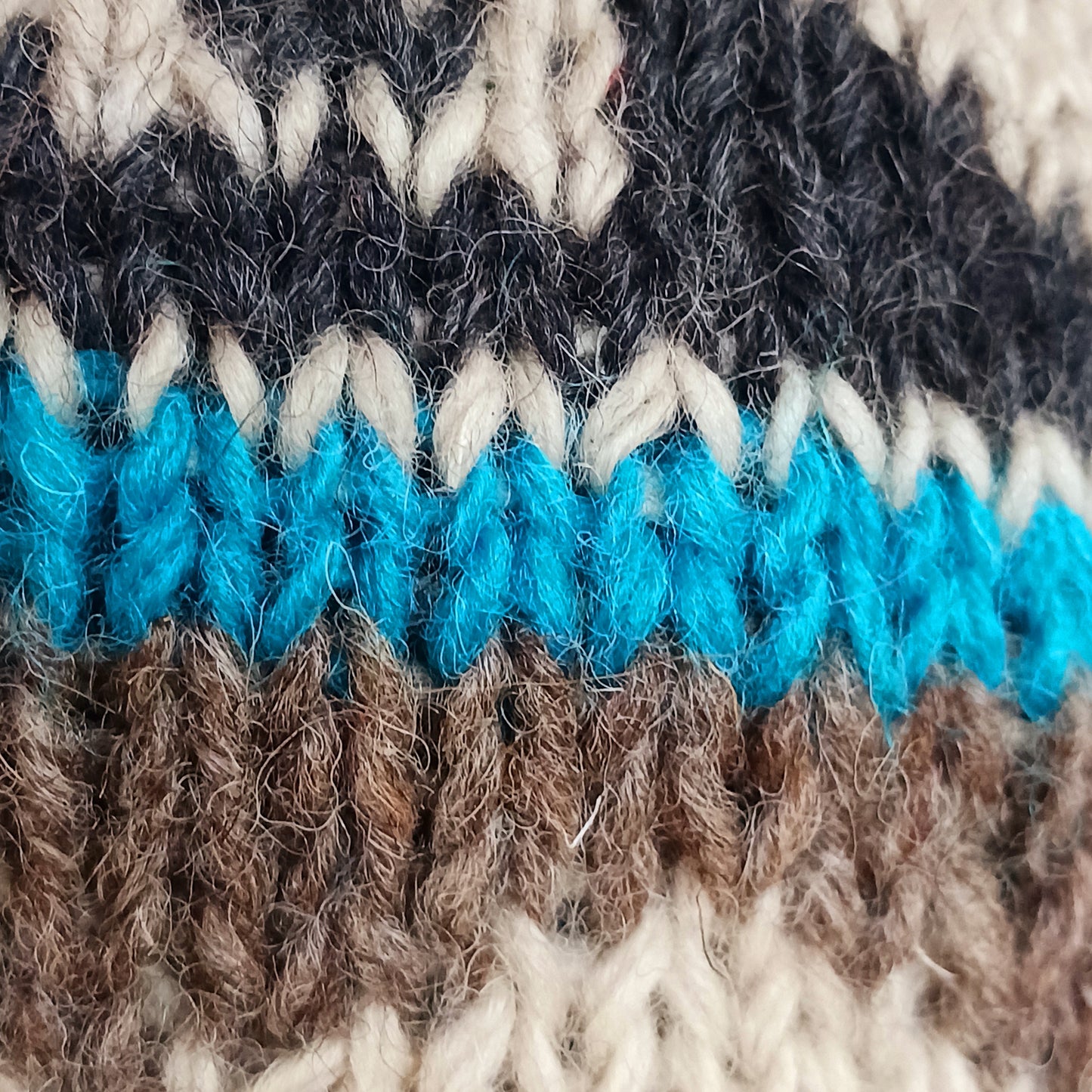 Stay cozy and stylish with our handmade chunky wool earflap hats, crafted in Nepal by skilled women artisans in Kathmandu. Each hat is 100% pure wool and features a soft polar fleece lining for extra warmth and comfort. Perfect for cold winter days, outdoor adventures, or adding a touch of handmade charm to your look.