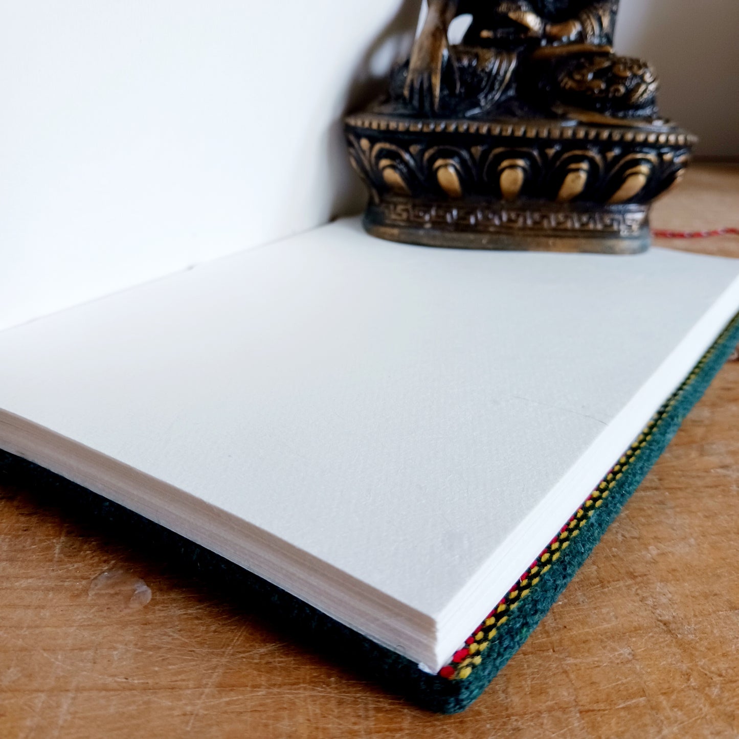 This beautifully bound notebook with handmade paper is from recycled cotton. An imaginative use for sari offcut material, the cover is edged and framed with pretty brocade material to complete a lovely and unique eco friendly stationery gift.