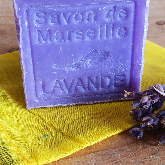 Indulge your senses with this Large Natural Marseille Soap Cube with Lavender Flowers, crafted by renowned French lavender experts Le Chatelard 1802. Traditionally made in Provence, this artisanal soap blends lavender oil and real lavender flowers for a gently bitter, aromatic fragrance and light exfoliation.