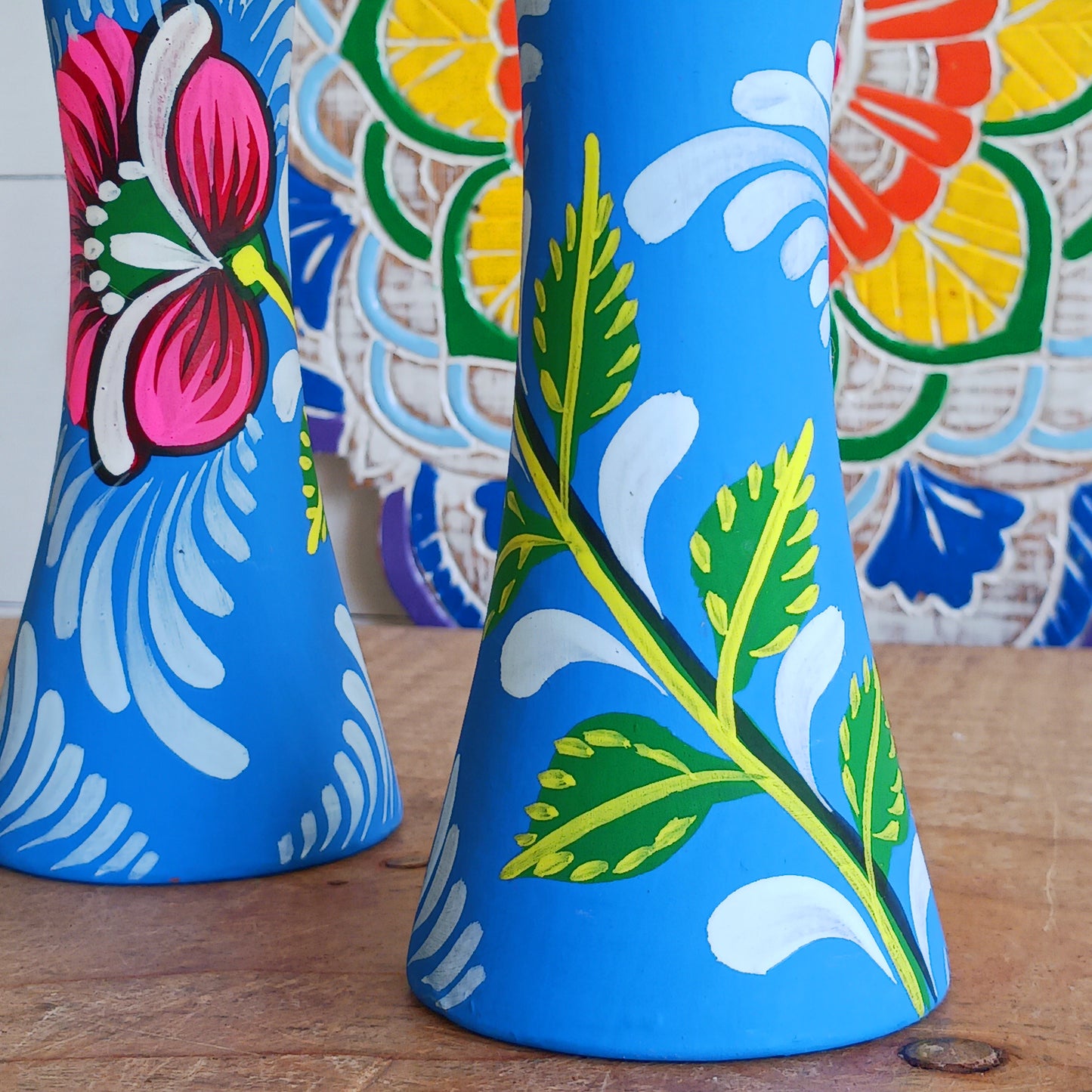 Hand painted in a vibrant blue hue and adorned with the Shapla (waterlily) flower — the national flower of Bangladesh, this fair trade candle holder is a true statement piece. Display it prominently or gift it to someone special as a unique, ethical, and meaningful present. Beautiful on its own or paired with others, it adds warmth, tradition, and cheerful design to any space.