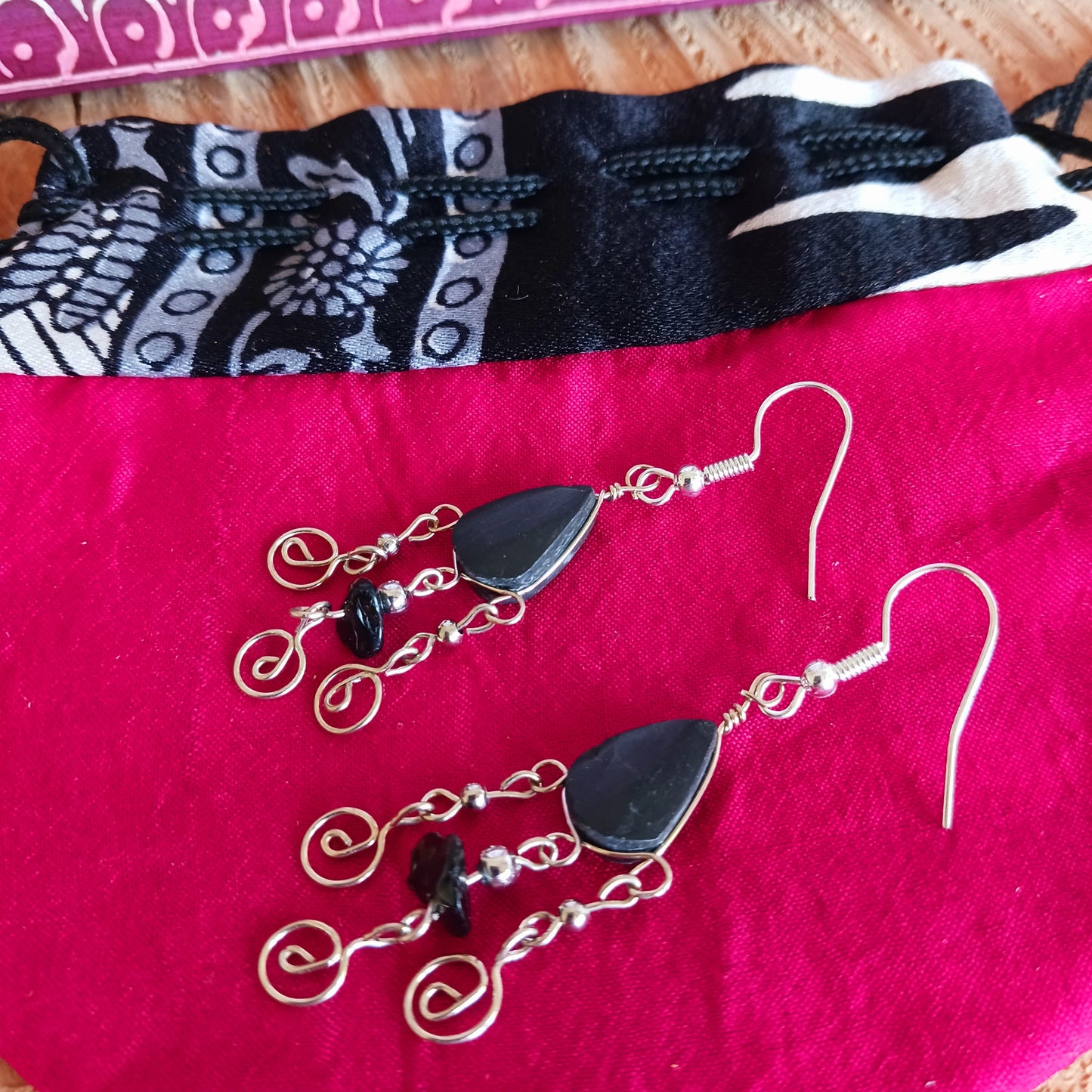 These beautiful spiral earrings feature a turquoise stone and three spirals. They dangle really nicely when worn, and are easy to dress up or down. The hooks are made from sterling silver.