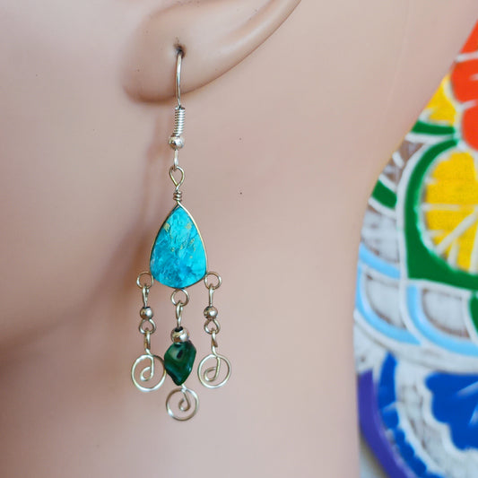 These beautiful spiral earrings feature a turquoise stone and three spirals. They dangle really nicely when worn, and are easy to dress up or down. The hooks are made from sterling silver.