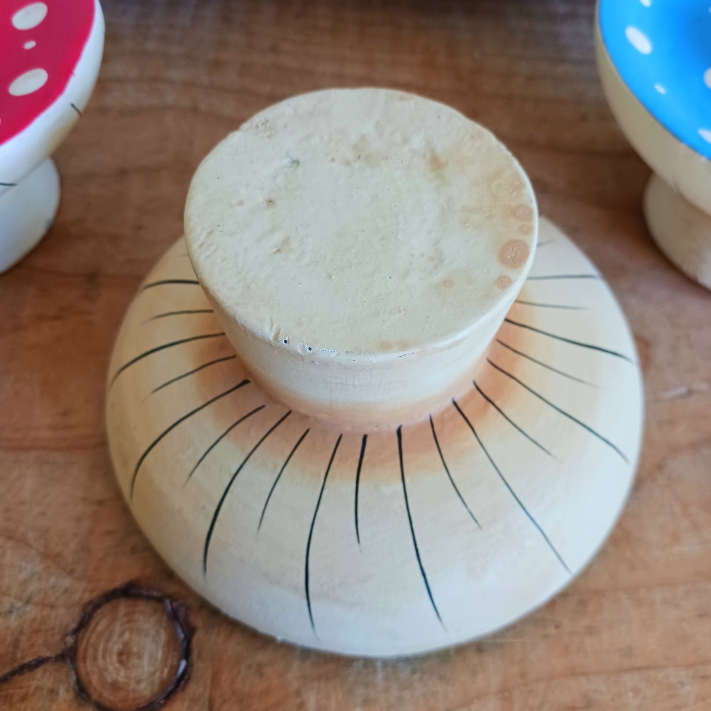 Bring woodland charm to your space with these hand-painted wooden mushroom incense holders. Each piece features a white stalk and a vibrant, spotty cap in your choice of blue, green or red. Designed with a central incense stick holder, these mushrooms are perfect for adding a whimsical, on-trend touch to your décor.