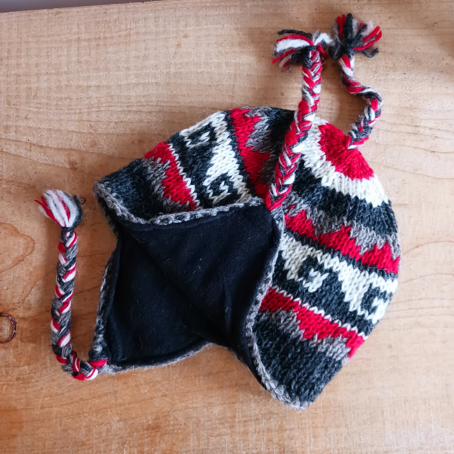 Stay cozy and stylish with our handmade chunky wool earflap hats, crafted in Nepal by skilled women artisans in Kathmandu. Each hat is 100% pure wool and features a soft polar fleece lining for extra warmth and comfort. Perfect for cold winter days, outdoor adventures, or adding a touch of handmade charm to your look.