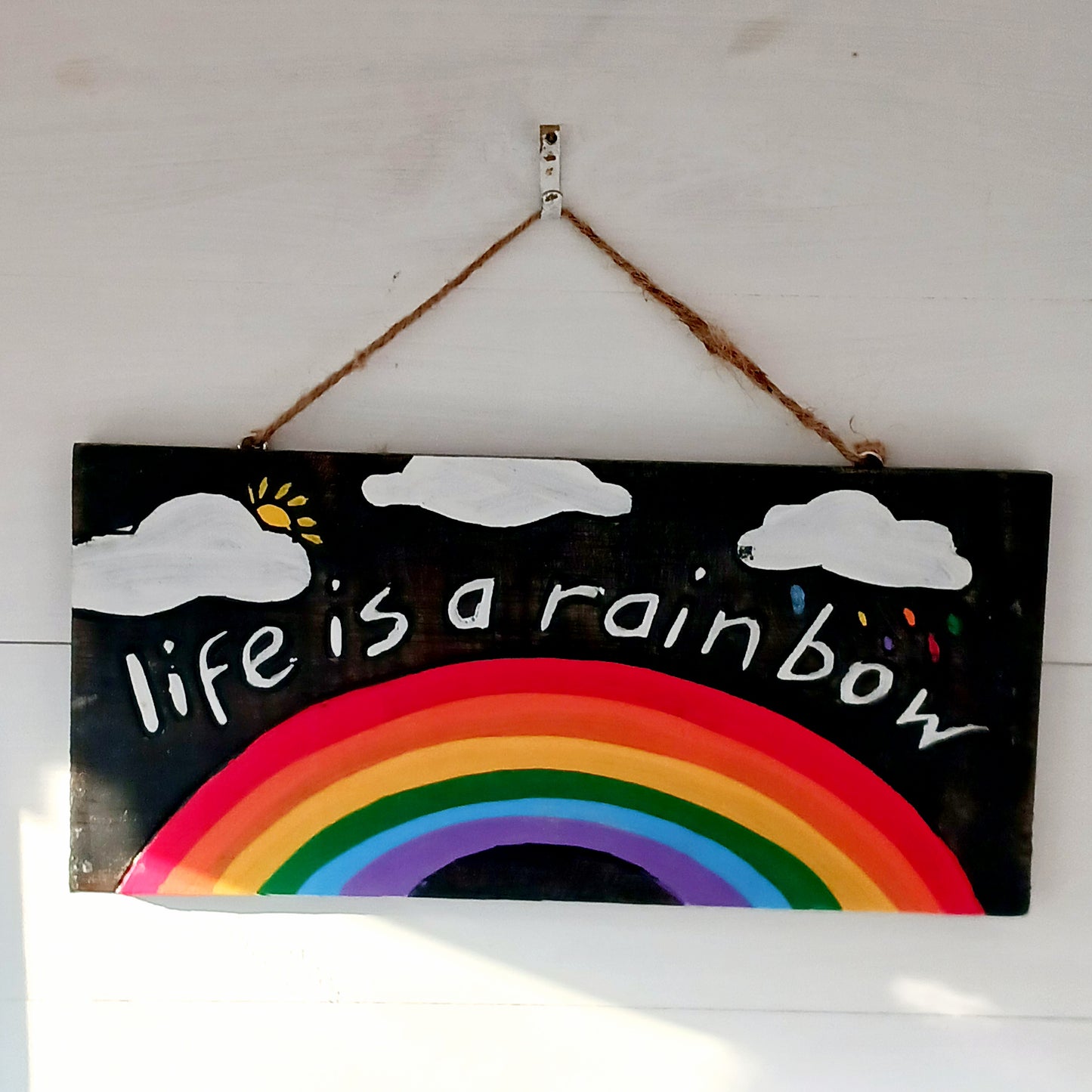 Hang this delightful plaque anywhere to bring a ray of sunshine to your day! A vibrant hand painted design on contrasting dark wood gives this plaque the full wow factor.