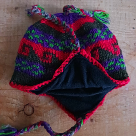 Stay cozy and stylish with our handmade chunky wool earflap hats, crafted in Nepal by skilled women artisans in Kathmandu. Each hat is 100% pure wool and features a soft polar fleece lining for extra warmth and comfort. Perfect for cold winter days, outdoor adventures, or adding a touch of handmade charm to your look.