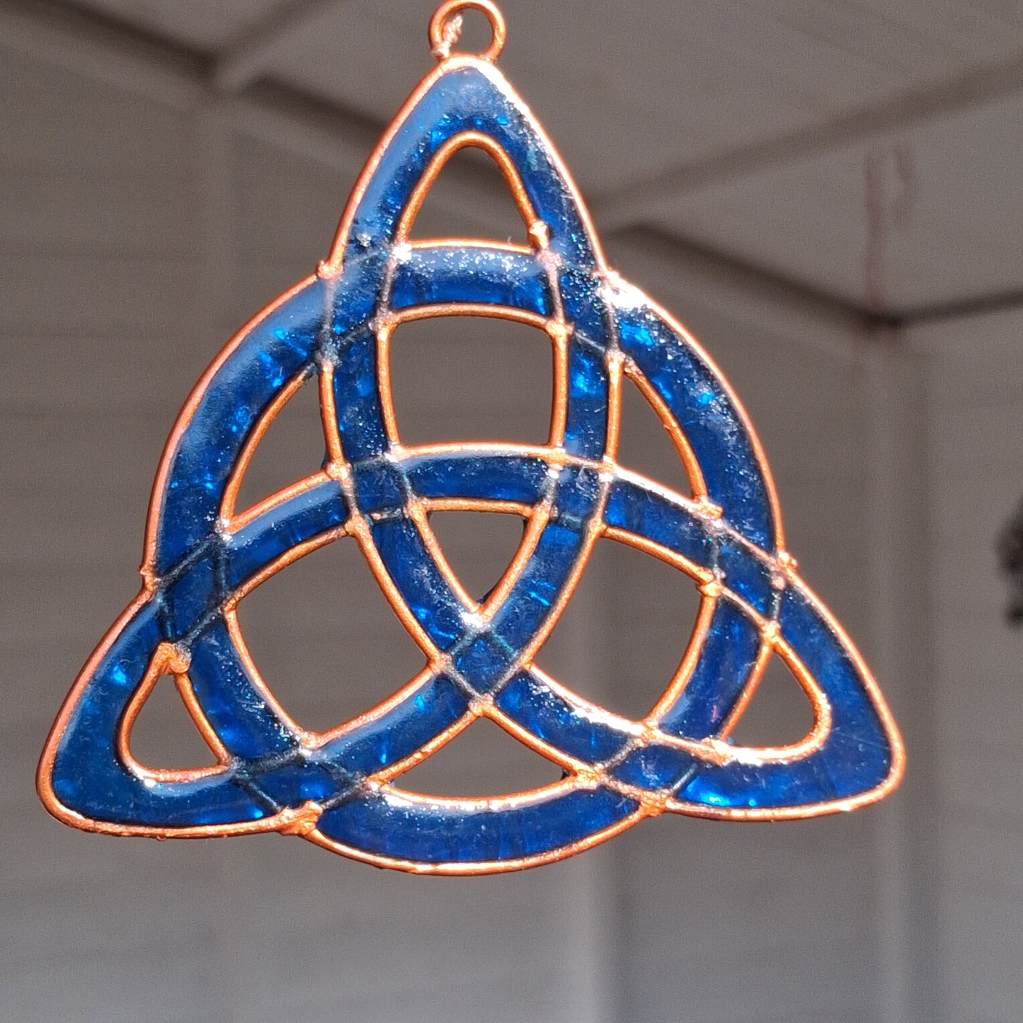 Invite the mystical energy of nature into the home with this little pagan suncatcher featuring a traditional triquetra design. Handcrafted in Bali, this enchanting piece is sure to infuse any space with a touch of earthly charm.