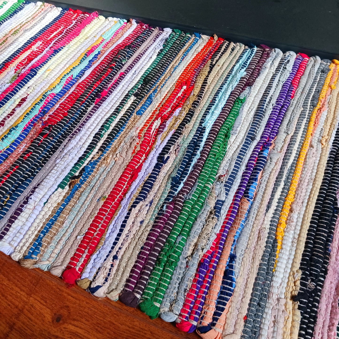 An Indian classic, this multi-coloured cotton and viscose striped rag rug is made from recycled materials and is machine-washable.