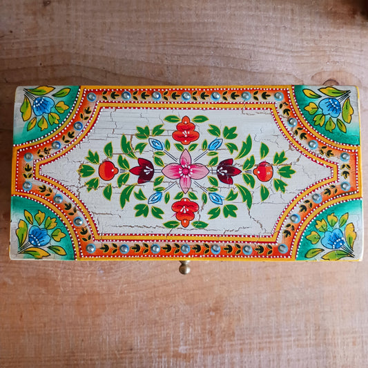 Elevate your home décor with the Zaha Large Decorative Box, a beautifully handcrafted storage piece made from sustainable mango wood. Expertly handmade and artistically hand-painted, this stunning box features intricate floral detailing on the lid and is finished with an elegant gold-coloured knob for a refined touch.