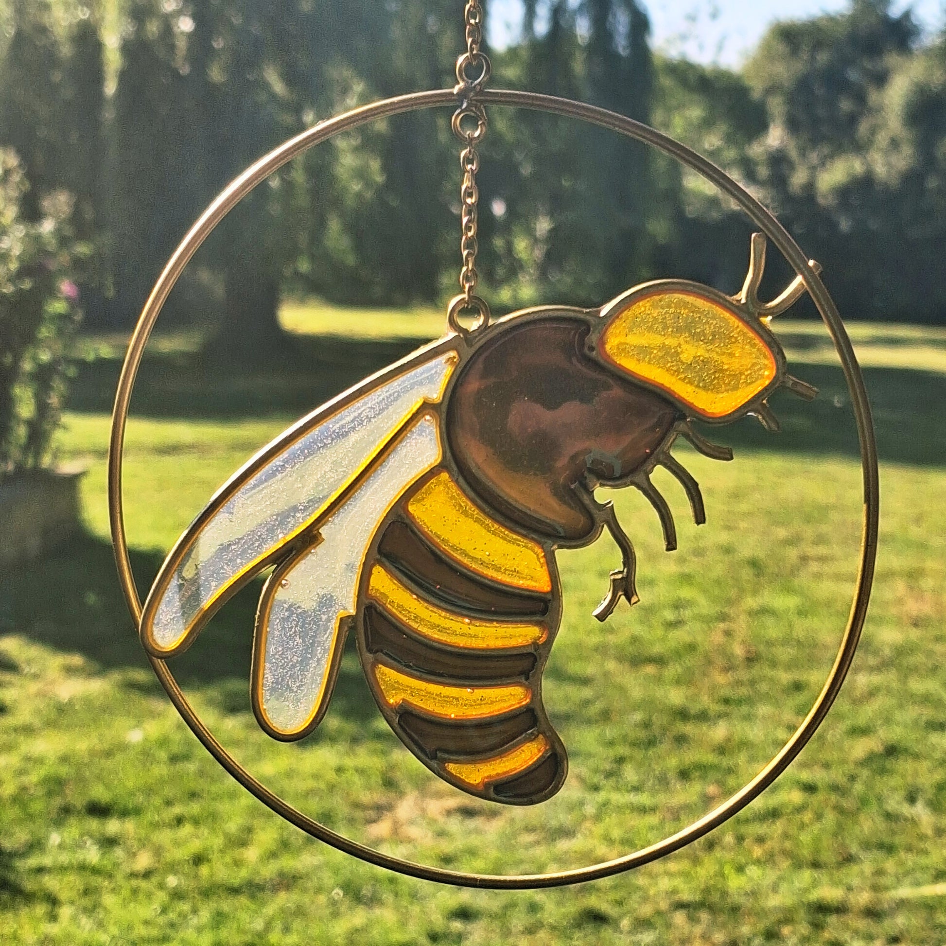 Add a touch of sunshine to the home with this summer bee suncatcher. This charming suncatcher features a beautifully detailed bee, star and crescent moon design made from metal and resin. Hang it in the window to catch the light and bring a cheerful, colourful glow to any room.