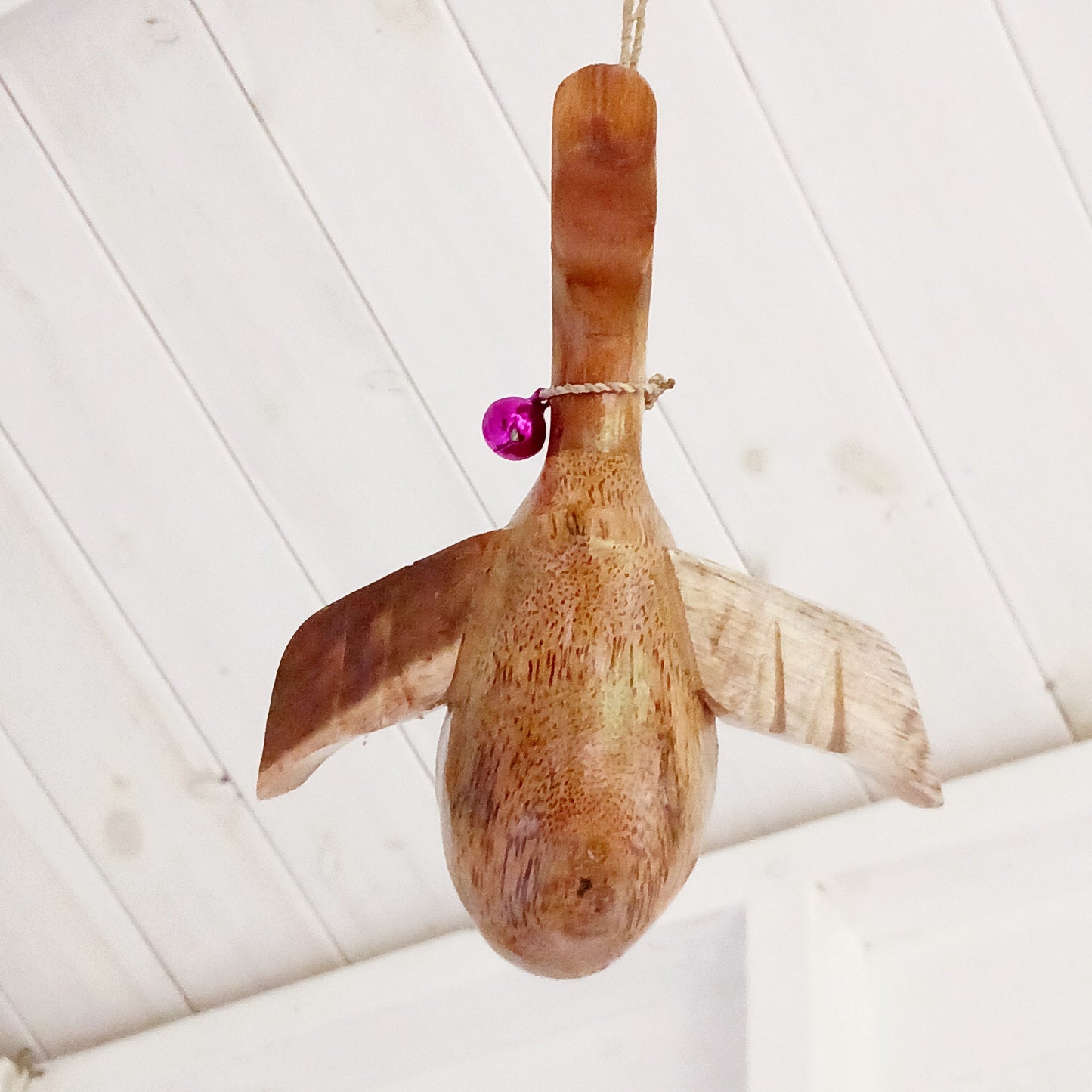 Bring a touch of whimsy and natural beauty to your home with this Handcarved Wooden Flying Duck. Each piece is meticulously crafted from solid wood, showcasing the artisan’s skill and attention to detail. The duck’s natural finish highlights the unique wood grain, adding a rustic charm that complements any interior style.
