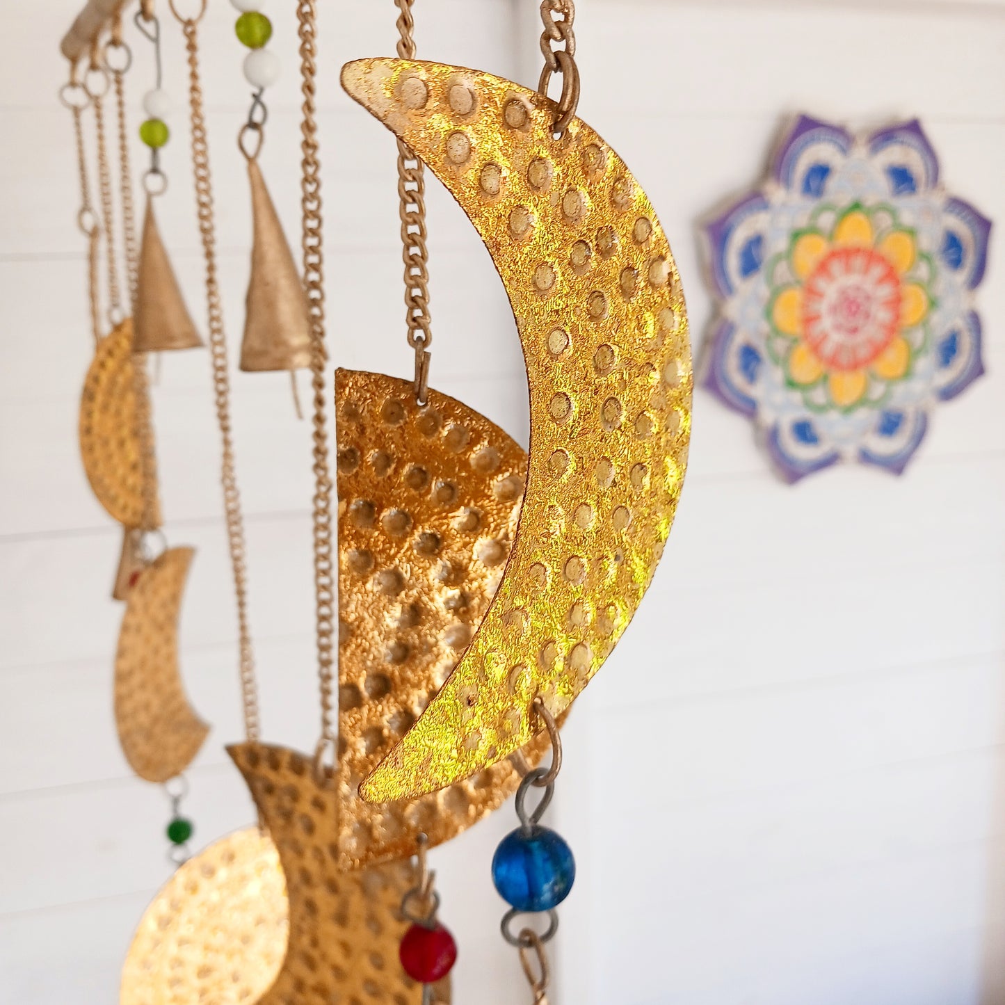 Add a little celestial beauty to your home with this unique brass Moon Phases Chimes. Made in India, it showcases the phases of the moon in stunningbrass, making it a striking piece for any space. Featuring intricate designs of each lunar phase, symbolizing the cycle of life and renewal.
