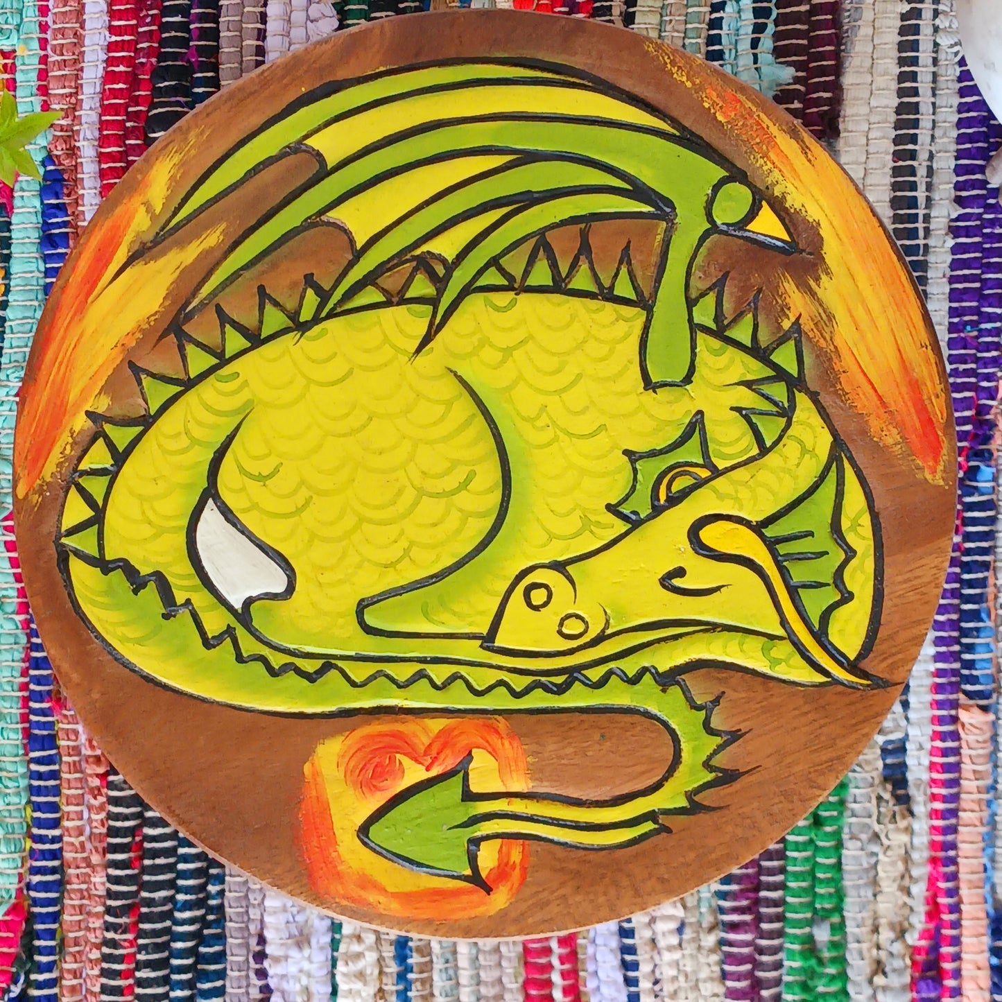 This lovely little handmade, carved and painted stool is Fairtrade from Thailand. The top of this stool has been carefully hand carved and then painted to show a peacefully curled, sleeping dragon surrounded by flames. These cheeky little items are very versatile making great stools for little bums or as tiny tables to add accent to your home. They can also be very useful as a step for those hard to reach high up shelves or even just to put your feet up on, and due to their small form are easy to store.