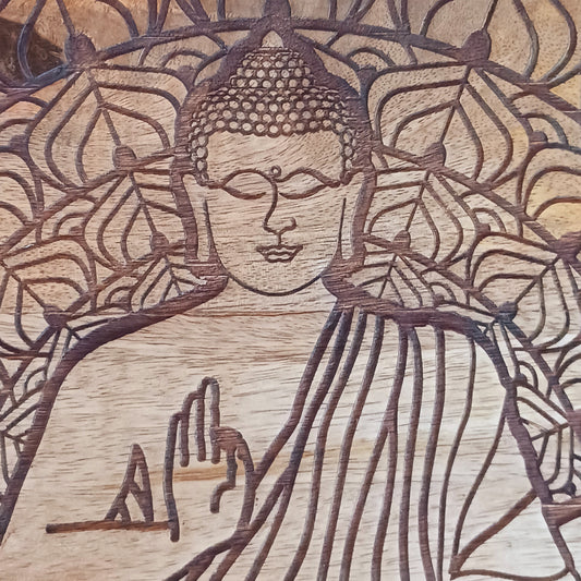 Bring peace and tranquillity to your home with this beautiful handcrafted mango wood table, featuring an intricately carved Buddha and Lotus Flower design on the tabletop. Combining traditional craftsmanship with spiritual symbolism, this unique wooden table makes a wonderful addition to a meditation space, Buddhist altar, yoga room or peaceful home sanctuary.