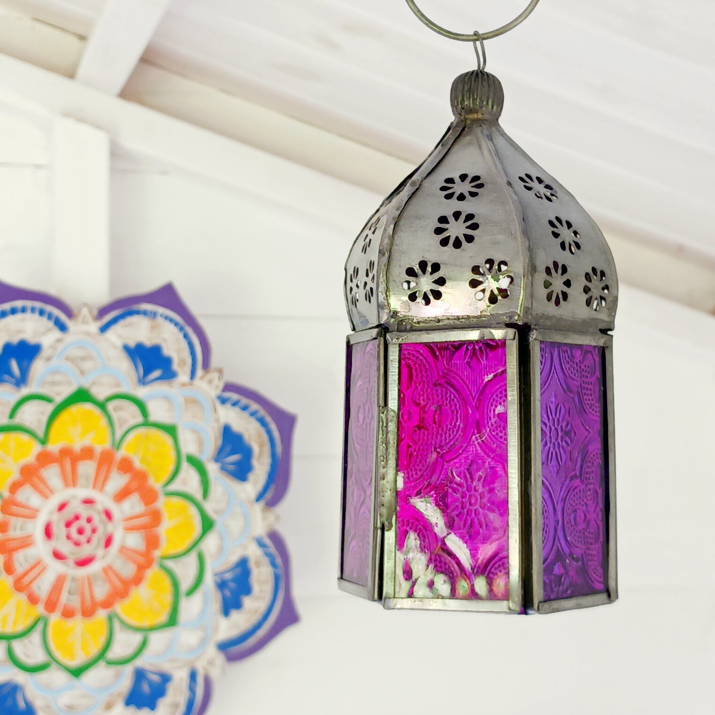 These small glass lanterns come in wonderful colours, featuring an intricate embossed pattern. They have a small hinged door that closes with a sliding catch. The small handle on the top is great for hanging the lanterns around your home. Perfect for adding a touch of warmth to your space.
