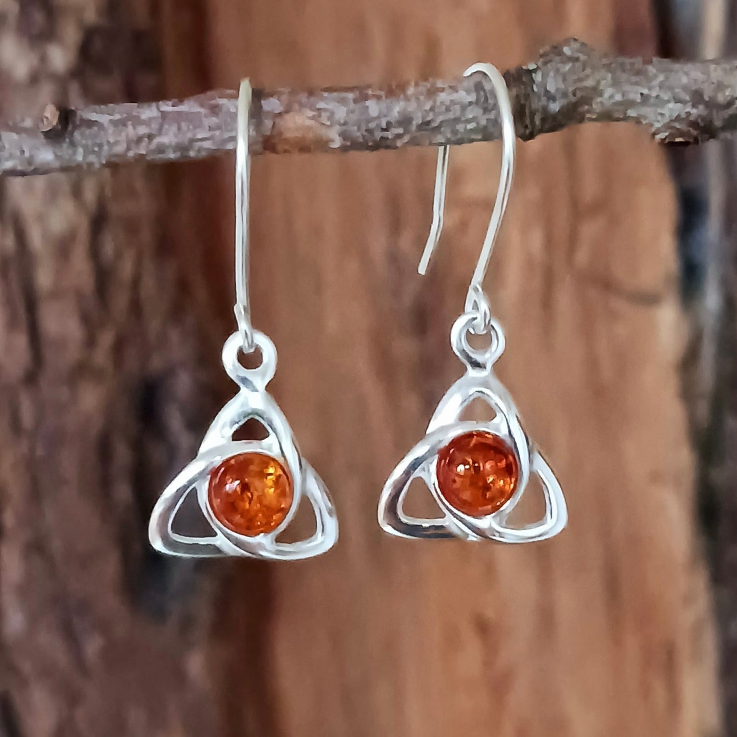 These beautiful amber goddess triquetra earrings have a stunning 4mm amber round cabochon, set within a lovey goddess triquetra knot.