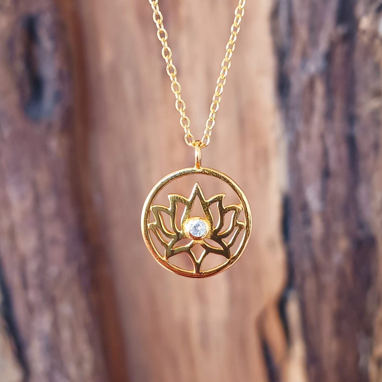 This pretty Lotus Flower pendant is gold plated on 925 silver and has a tiny cz crystal at the centre. It comes on a fine gold plated on 925 silver chain. The lotus flower meaning varies from culture to culture. In general, the lotus commonly serves as a sacred for purity, rebirth, and strength. Because lotuses rise from the mud without stains, they are often viewed as a symbol of purity.