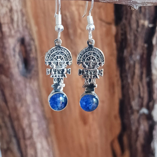 These intricate earrings feature a tiny image of the Tumi, a type of ceremonial knife used in ancient Peru by the Moche culture. &nbsp;They feature a mythical character usually identified with the god Naymlap.&nbsp;  All hooks are silver plated and these earrings come with crushed lapis lazuli stone.  Ideal for a night out, for dressing up your boho look or as a gift for family or friends.