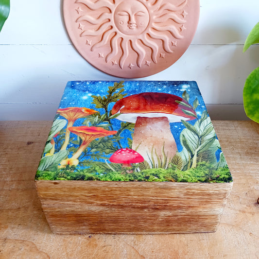 Add a touch of woodland charm to your home with this Wooden Mushroom Square Box, featuring a playful mushroom design. Combining practical storage with whimsical style, this decorative wooden box is perfect for keeping jewellery, trinkets and other small treasures safely tucked away.
