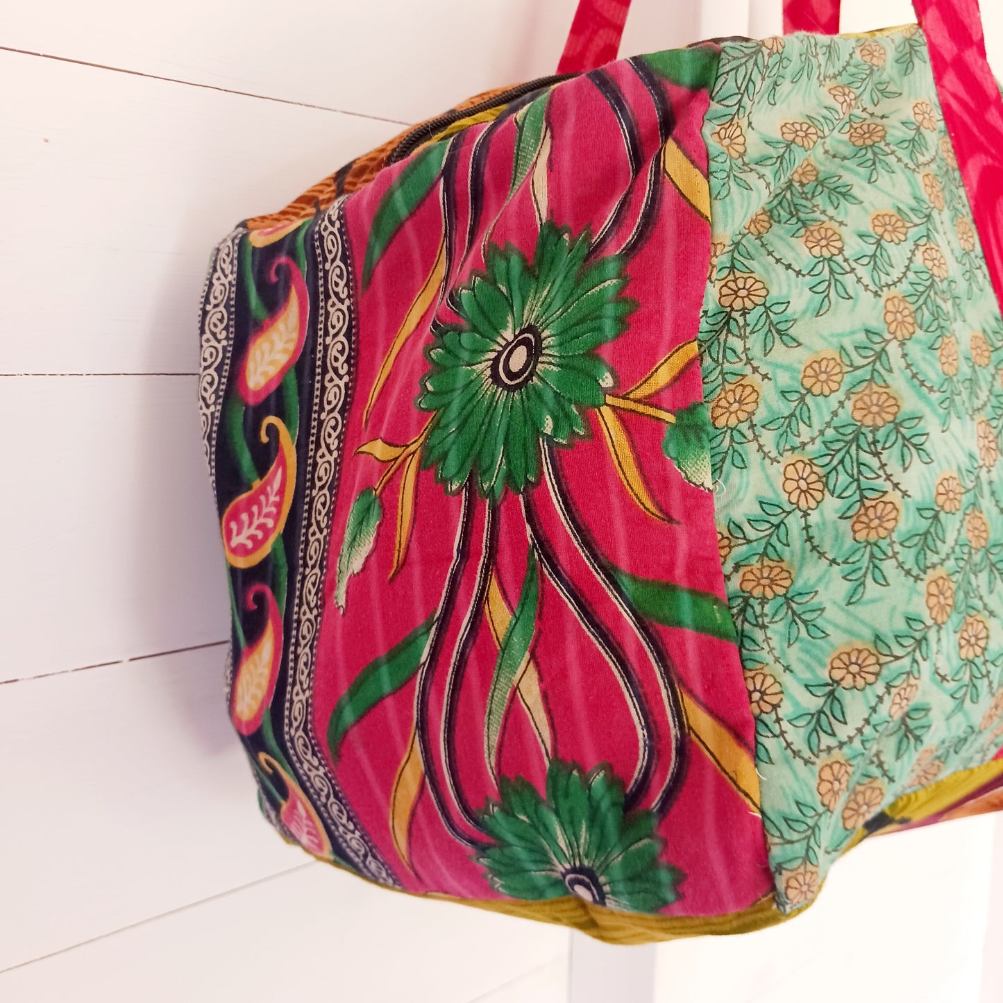 This summer holdall is an attractive accessory for weekends away with generous length handles, a zipped top and a useful front zipped pocket for mobile and keys. Each bag is one of a kind!