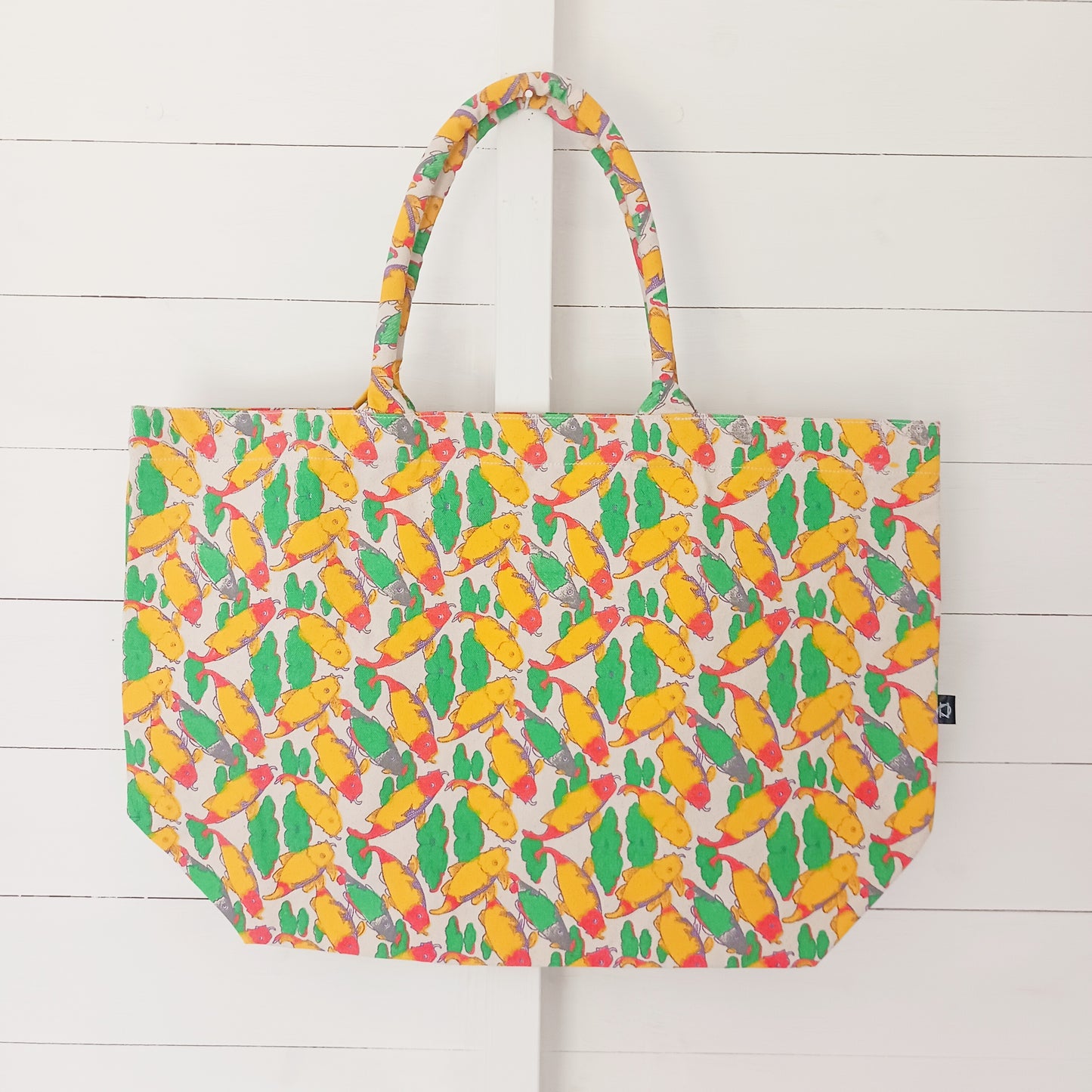 This sturdy Eco-friendly Tote Bag is a versatile bag that can be used as a shopping bag, for picnics or a beach bag. &nbsp;This quirky bag features a vibrant Koi Carp design on both sides.&nbsp; The bag has a secure fastening at the top, and also has zipped a pouch inside.