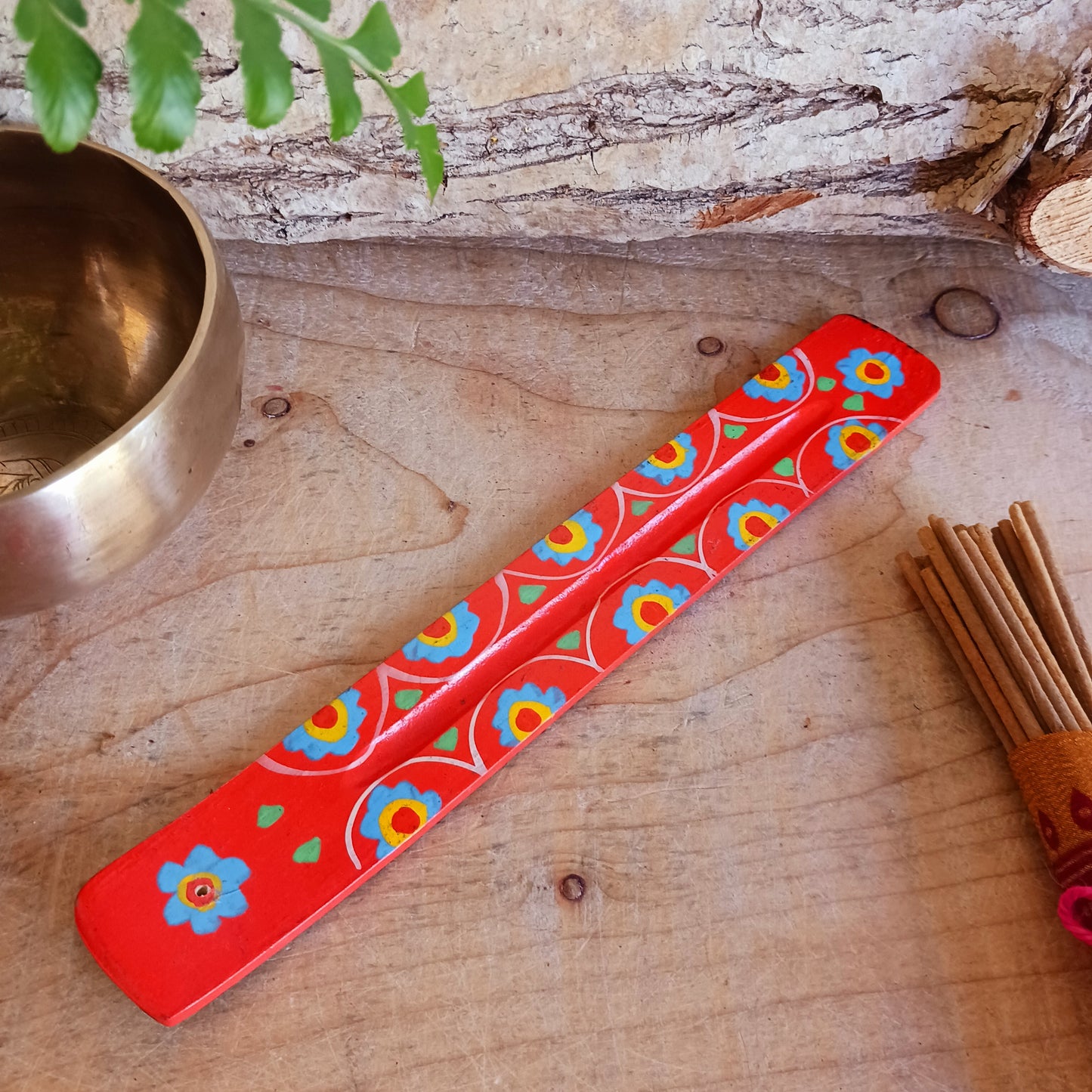 A classic shaped incense holder handmade from sustainable mango wood and hand painted in colourful Indian Truck Art designs. It has a single end incense stick holder at one end. A lovely ornamental piece of Indian décor and a nice gift item.