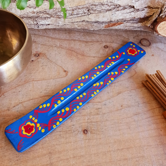 A classic shaped incense holder handmade from sustainable mango wood and hand painted in colourful Indian Truck Art designs. It has a single end incense stick holder at one end. A lovely ornamental piece of Indian décor and a nice gift item.