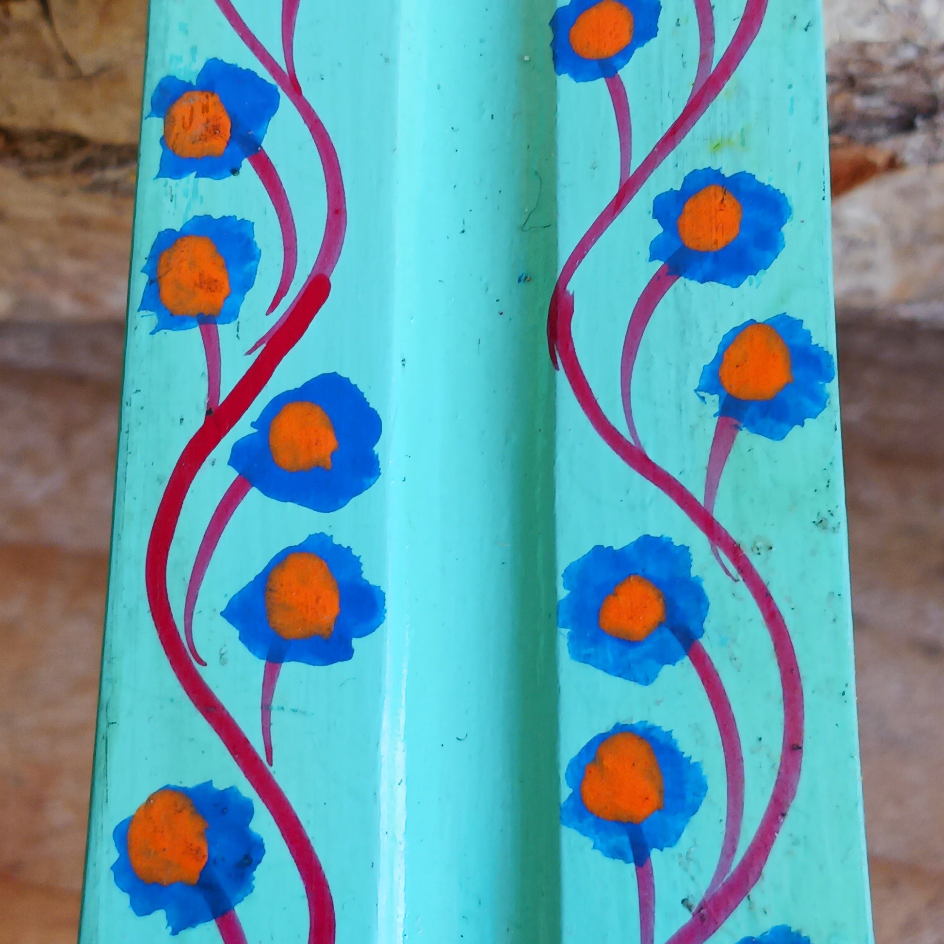 A classic shaped incense holder handmade from sustainable mango wood and hand painted in colourful Indian Truck Art designs. It has a single end incense stick holder at one end. A lovely ornamental piece of Indian décor and a nice gift item.