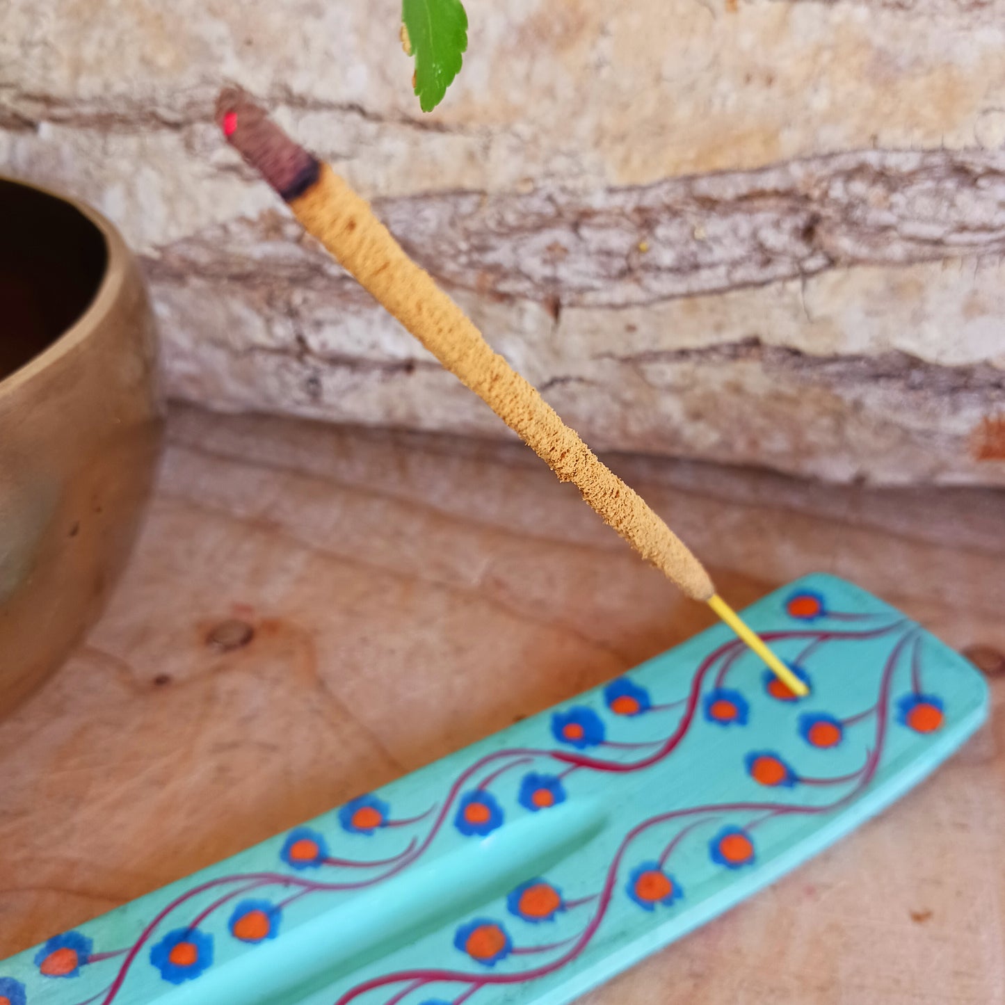 A classic shaped incense holder handmade from sustainable mango wood and hand painted in colourful Indian Truck Art designs. It has a single end incense stick holder at one end. A lovely ornamental piece of Indian décor and a nice gift item.