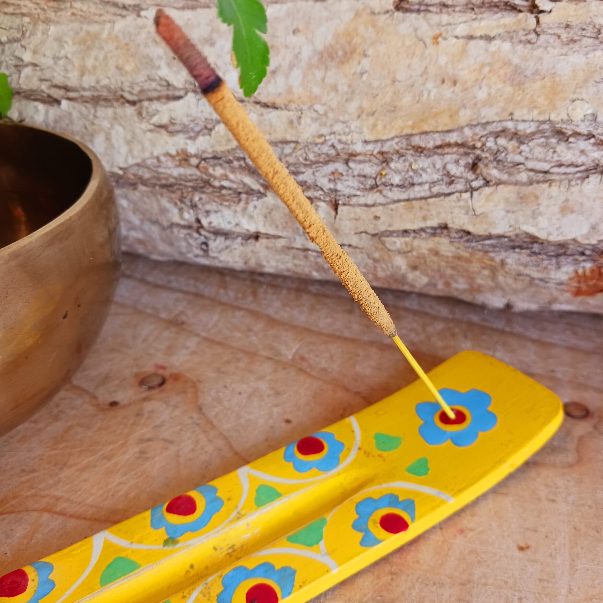 A classic shaped incense holder handmade from sustainable mango wood and hand painted in colourful Indian Truck Art designs. It has a single end incense stick holder at one end. A lovely ornamental piece of Indian décor and a nice gift item.