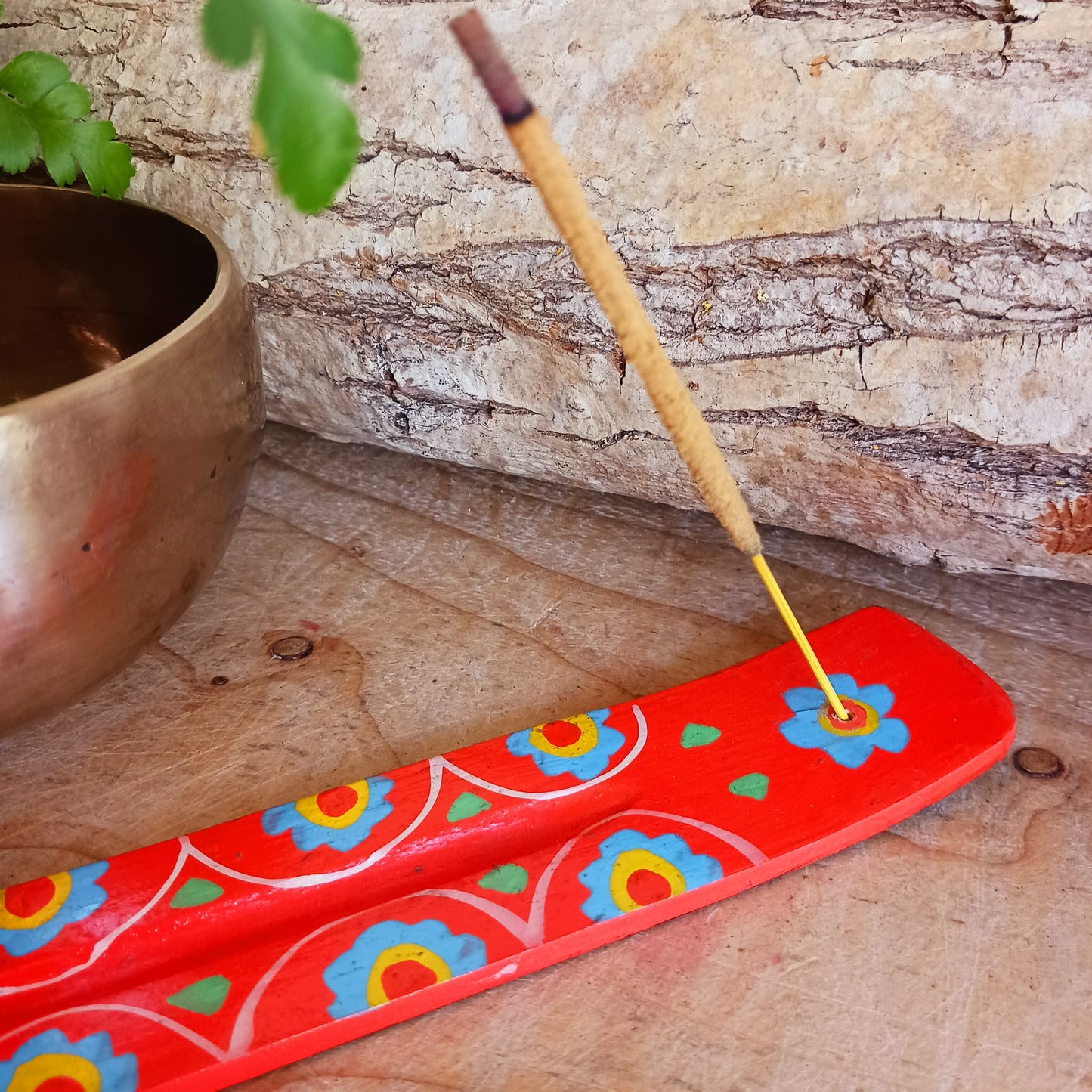 A classic shaped incense holder handmade from sustainable mango wood and hand painted in colourful Indian Truck Art designs. It has a single end incense stick holder at one end. A lovely ornamental piece of Indian décor and a nice gift item.