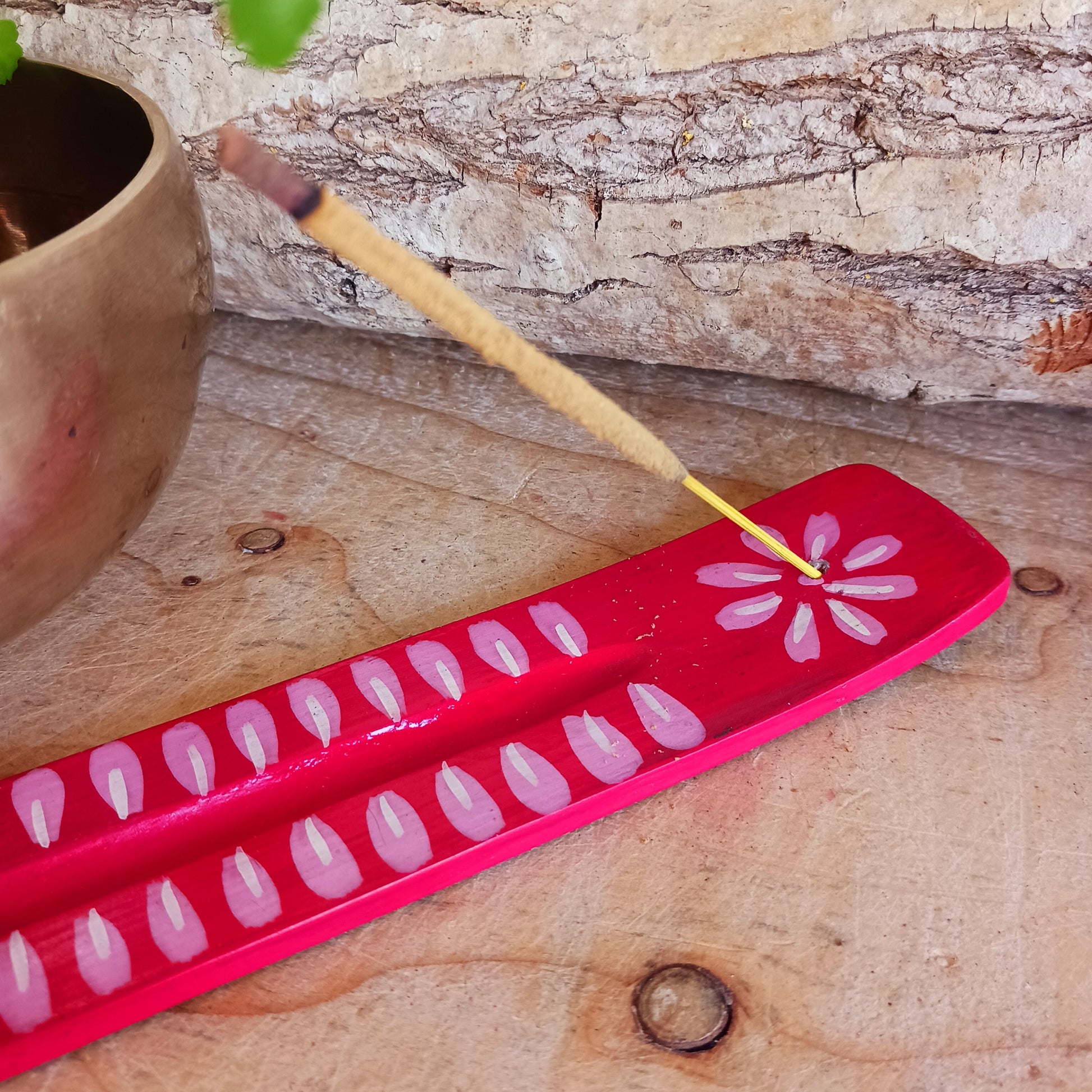 A classic shaped incense holder handmade from sustainable mango wood and hand painted in colourful Indian Truck Art designs. It has a single end incense stick holder at one end. A lovely ornamental piece of Indian décor and a nice gift item.