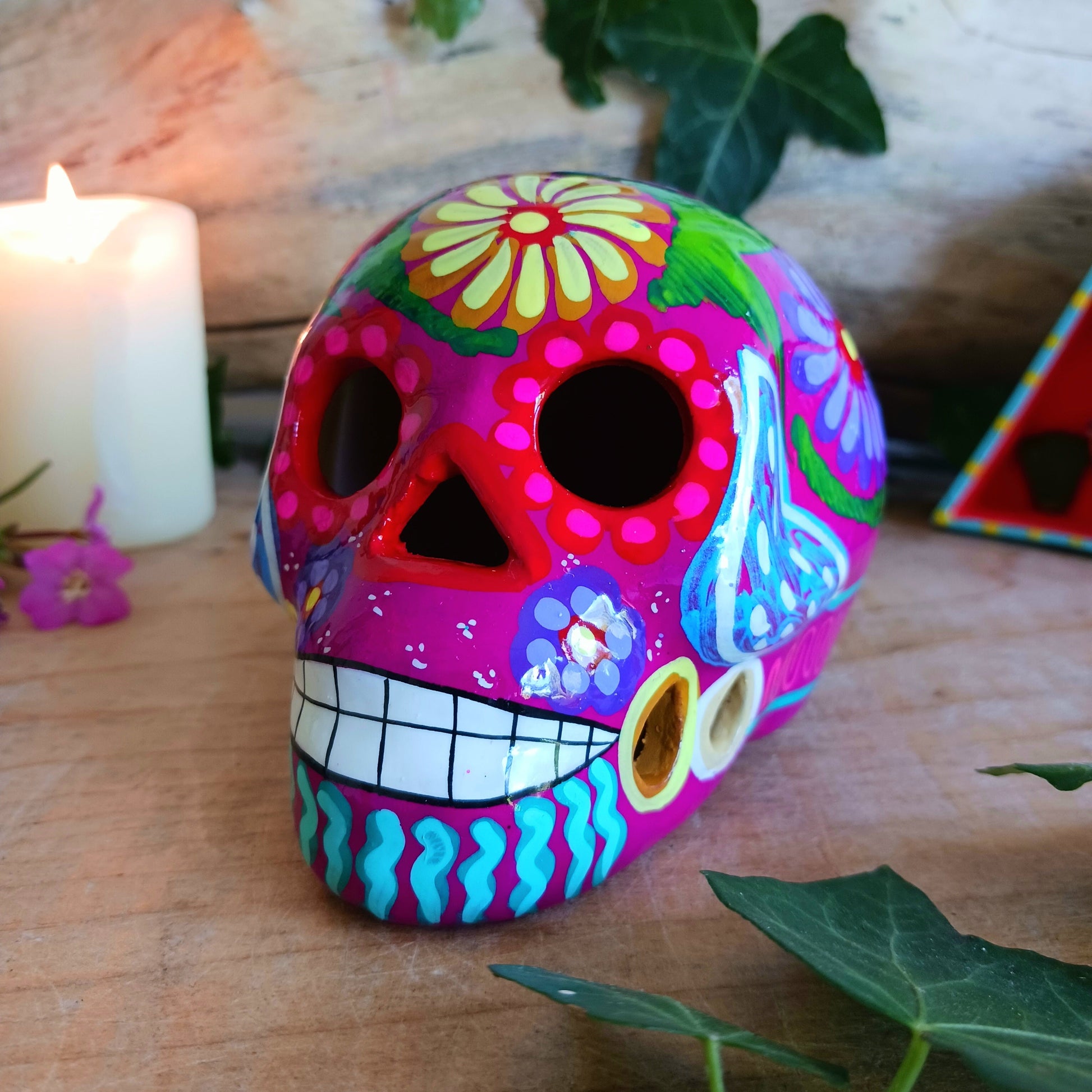 These fun ceramic sugar skull ornaments have been beautifully painted in bright colours and finished with a high shine glaze.&nbsp;

They are a popular item during Día de Los Muertos or Day of the Dead festivities, held in Mexico every November to celebrate welcoming the souls of their deceased relatives back for a time of food, drink and celebration.