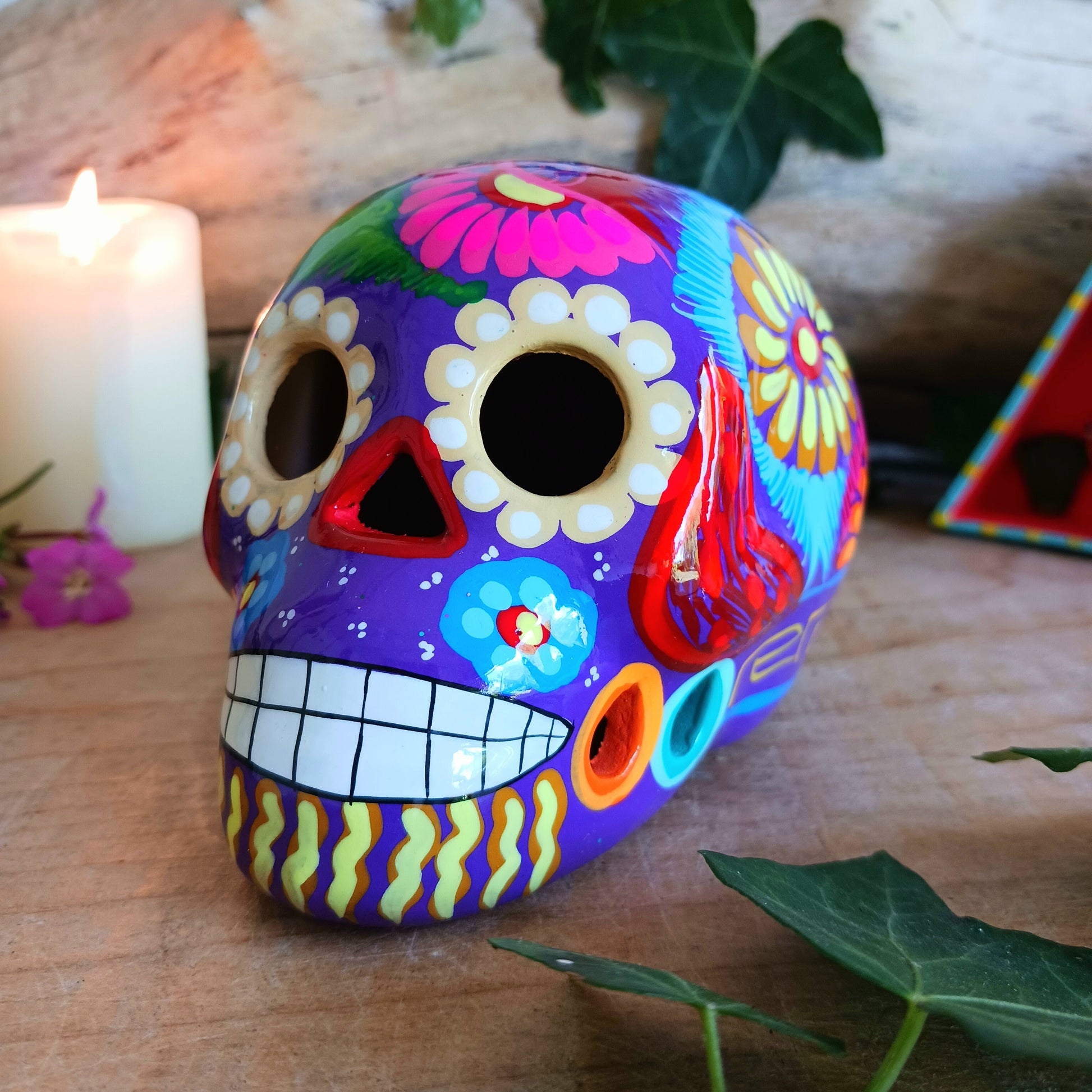 These fun ceramic sugar skull ornaments have been beautifully painted in bright colours and finished with a high shine glaze.&nbsp;

They are a popular item during Día de Los Muertos or Day of the Dead festivities, held in Mexico every November to celebrate welcoming the souls of their deceased relatives back for a time of food, drink and celebration.

These skulls are also make a bright edition to any home.