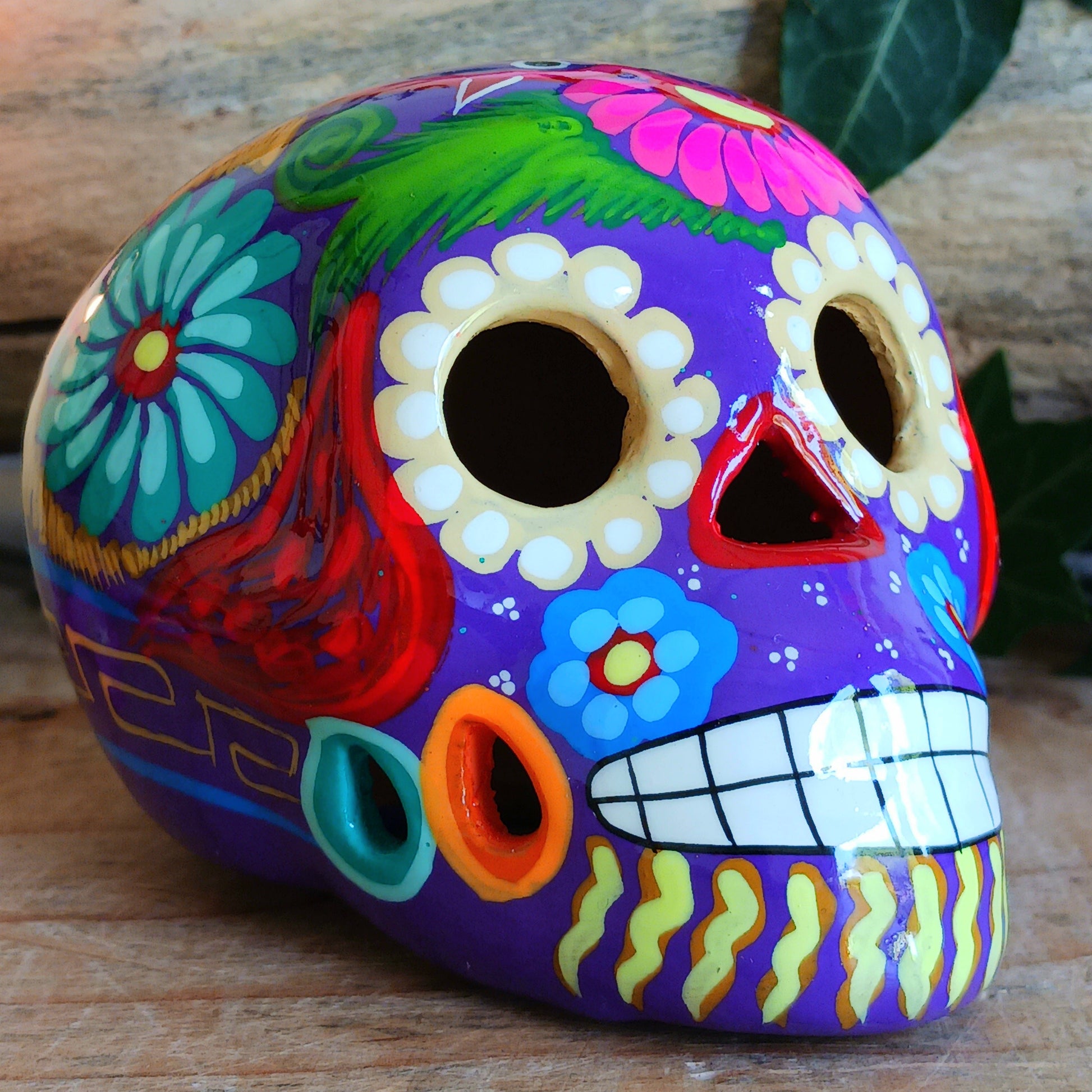 These fun ceramic sugar skull ornaments have been beautifully painted in bright colours and finished with a high shine glaze.&nbsp;

They are a popular item during Día de Los Muertos or Day of the Dead festivities, held in Mexico every November to celebrate welcoming the souls of their deceased relatives back for a time of food, drink and celebration.

These skulls are also make a bright edition to any home.